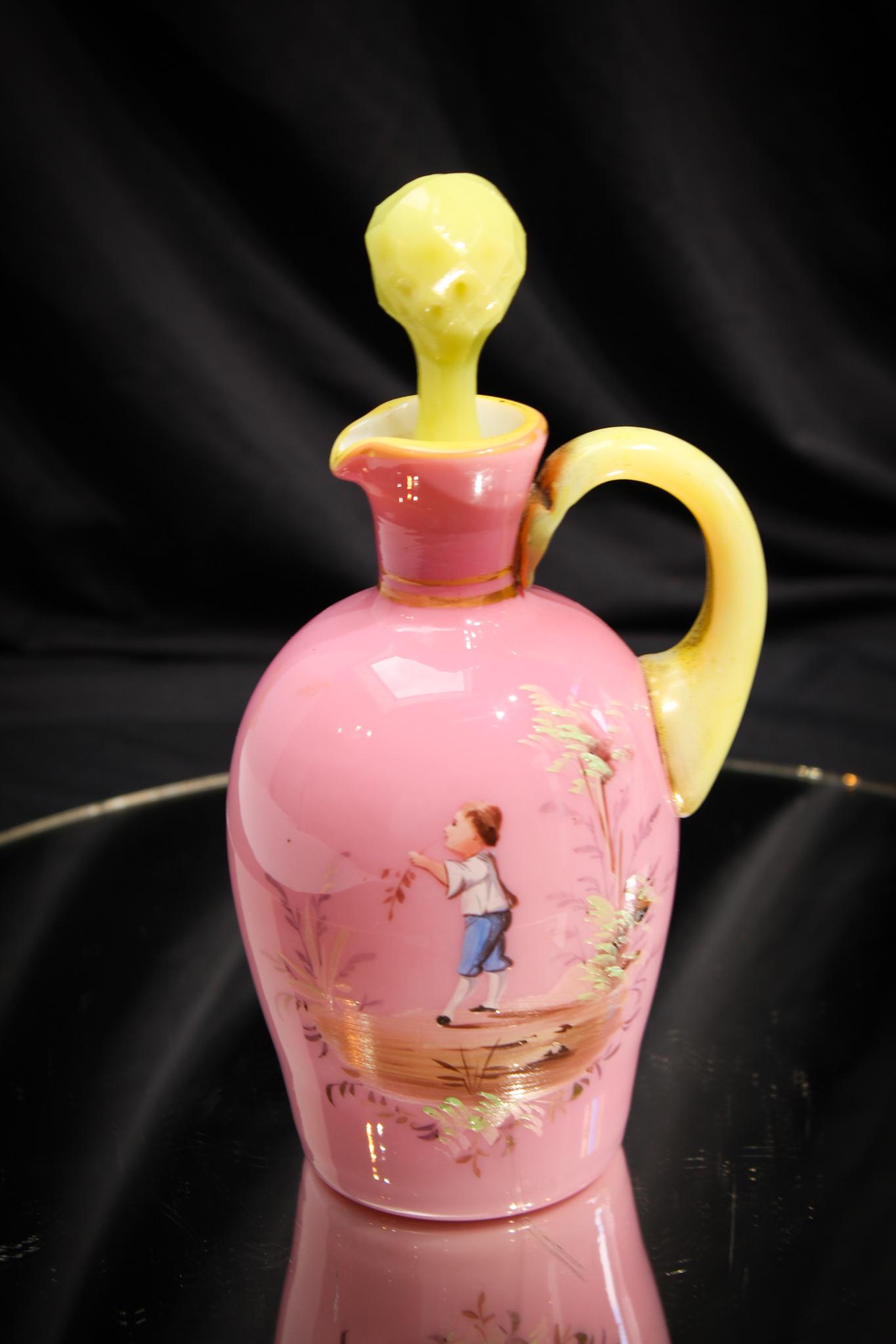 Victorian Mary Gregory Enameled Pink Cased Cruet: So charming is the Victorian child on this pink cased Victorian cruet. Well executed with vivid colors. Cruet has an applied custard yellow stopper and handle. Measures 7 1/4" tall.