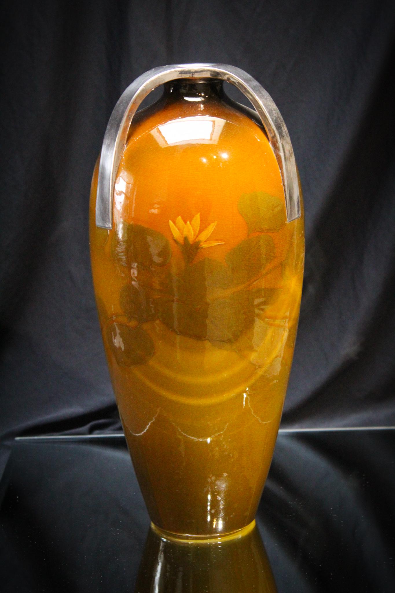 Rookwood Standard Glaze Daly With Silver Moutings: How unusual. This Rookwood vase in standard glaze is artist signed, Matt Daly. This piece has the most unique silver mountings. Beautiful floral dÃ©cor. Light crazing and minor surface scratching th