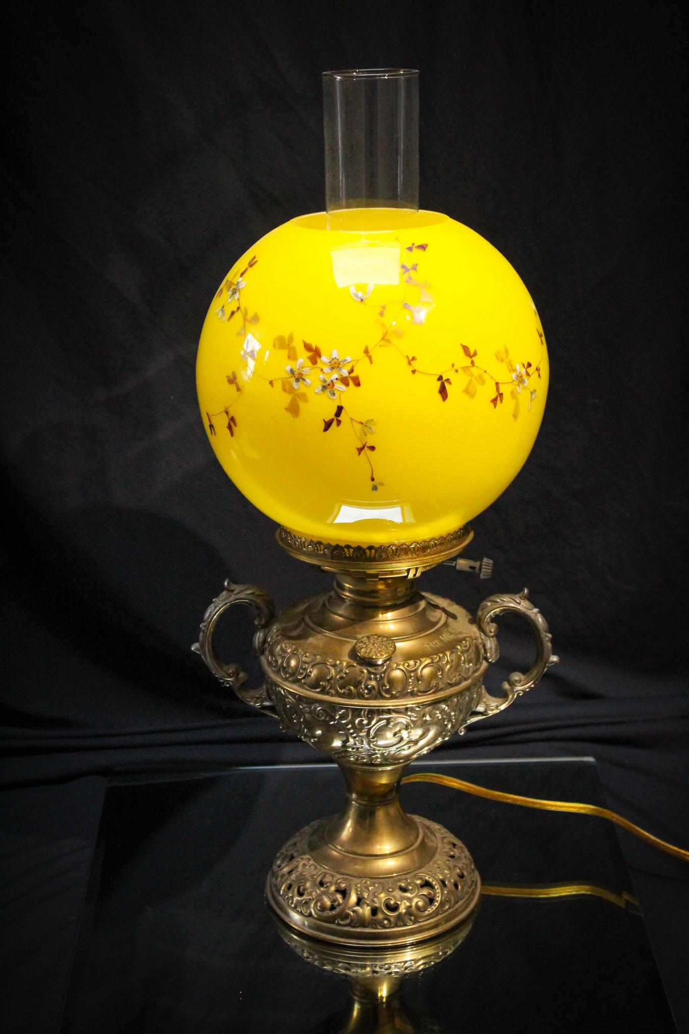 Victorian New Rochester Jr. Banquet Parlor Lamp: Perfect size on this Victorian Jr. Parlor banquet lamp. Lamp is signed New Rochester. Lamp is complete with yellow cased glass enameled florals shade. Lamp has been wired for electric use.