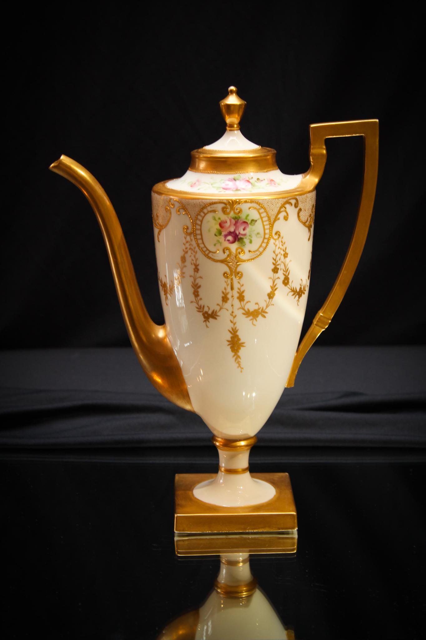 Belleek Porcelain Coffee Pot: Do you ever truly get tired of seeing a beautiful rose? Apparently this consignor didn't. We don't either. Amazing decoration on this Belleek coffee pot. Measures 10 1/2" tall.