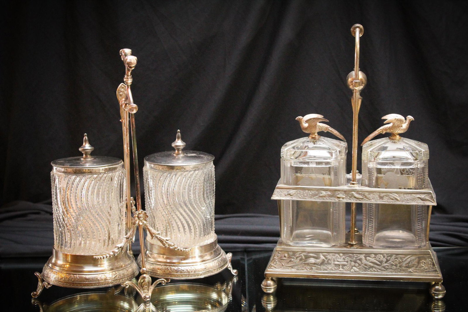 2 pc Lot Victorian Silverplate Double Pickle Castors: A lot of two pickle castors. Perfect examples. One Meriden and one Miller & Co. Both complete with original jars. The Meriden Castor has bird finials on the jar lids, the jars are decrated with birds 