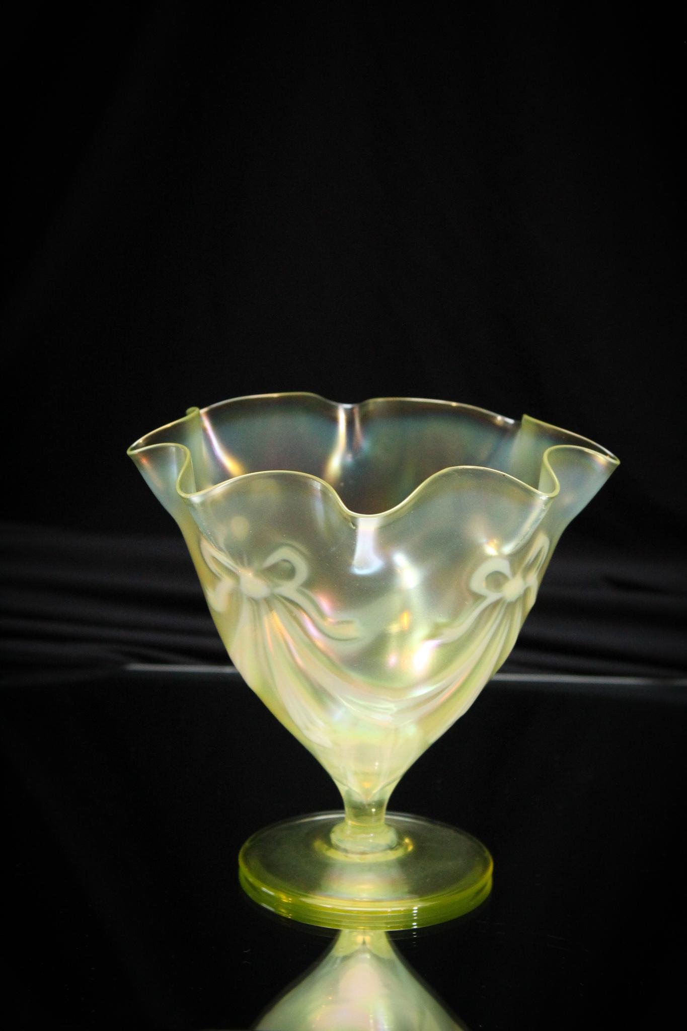 Victorian Vaseline Opalescent Irridescent Vase: Attributed to Walsh or Powell, this lovely is beautiful. Nice size pedestal vaseline opalescent ovoid form vase complimented by an opalescent bow pattern and irridescent finish. Measures 5 3/4" tall.