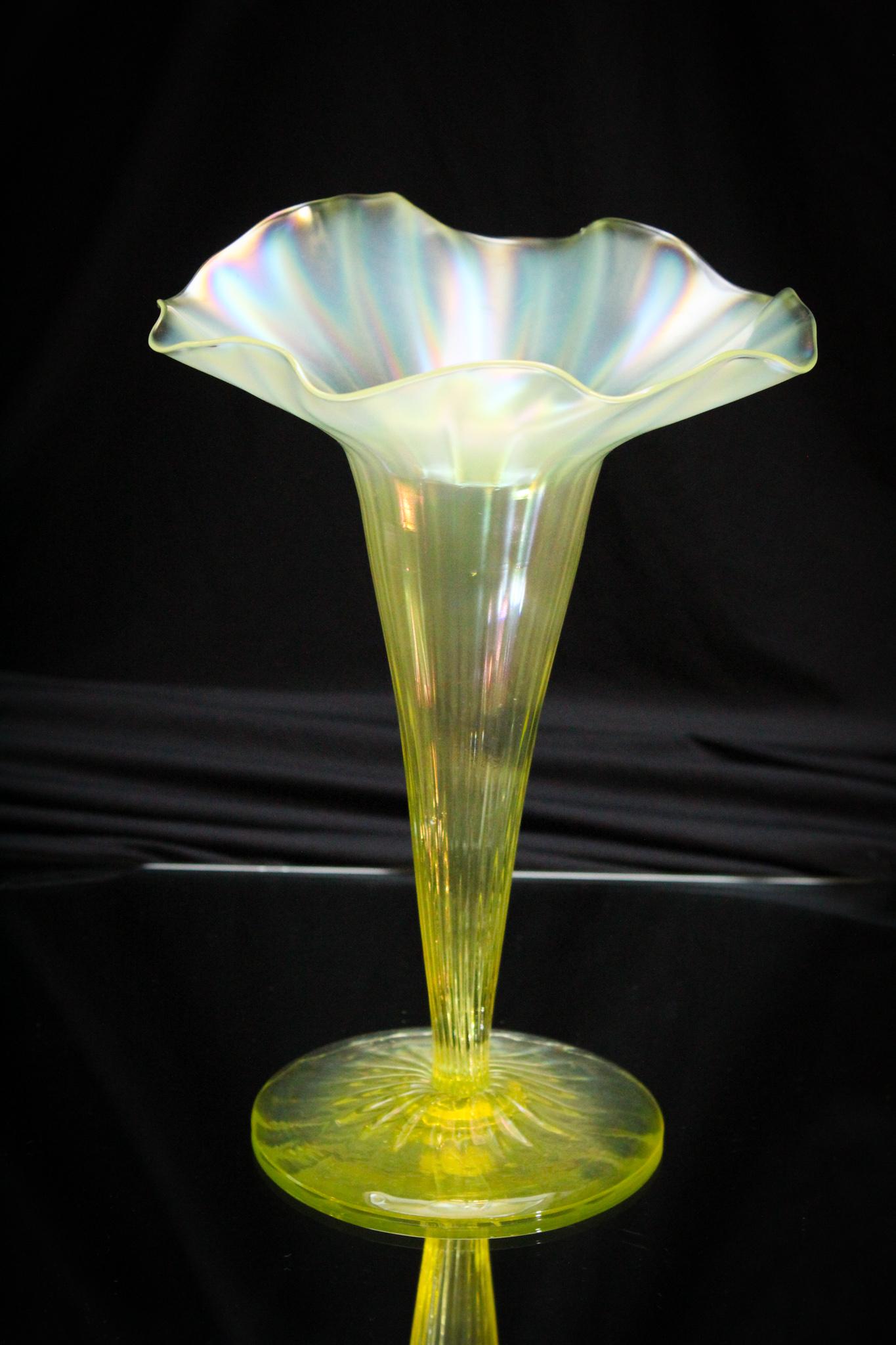 Vaseline Irridescent Jack in Pulpit Lily Vase: Identified as John Welsh Welsh, and seldom seen as this form, this piece is a lilly vase with a back side pulled up to emulate a jack in the pulpit form. Irridescent finish to glass surface. Measures 