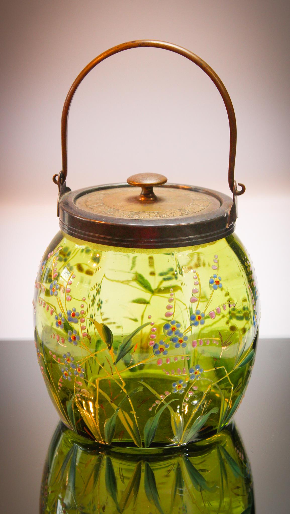 Victorian Enameled Glass Green Biiscuit Jar: We love this color. Such an un usual color of green. Almost Kermit the Frog green when held to the light. Highly decorate with wildflower decoration. Measures 6" tall to the rim.