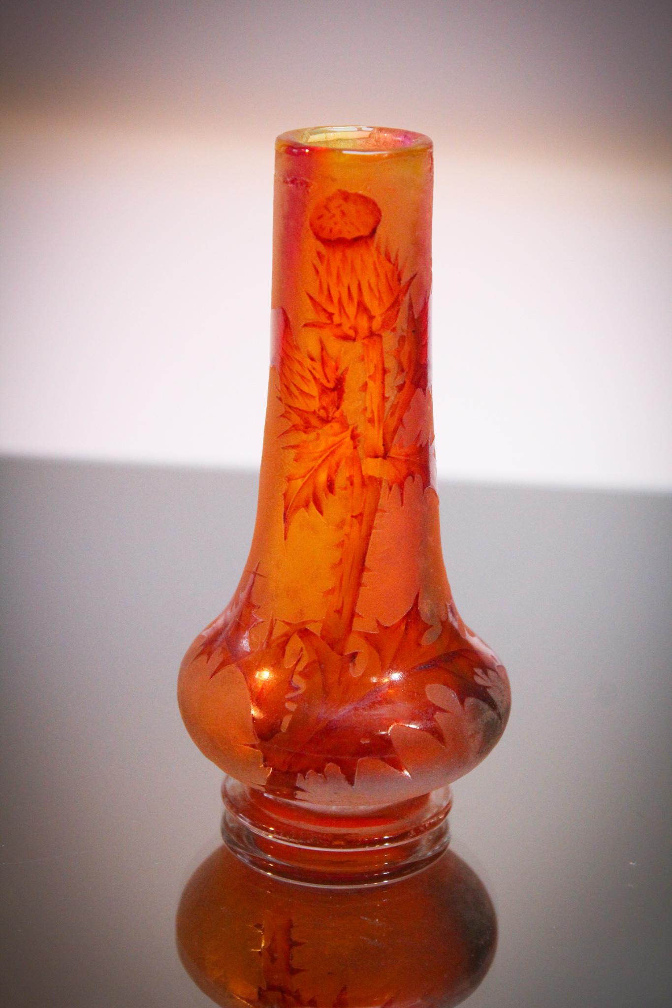 Daum Nancy Cameo Glass Vase: Signed Daum Nancy tangerine French cameo glass vase with thistle decoration. Very good detail. Measures 4 3/4" tall.