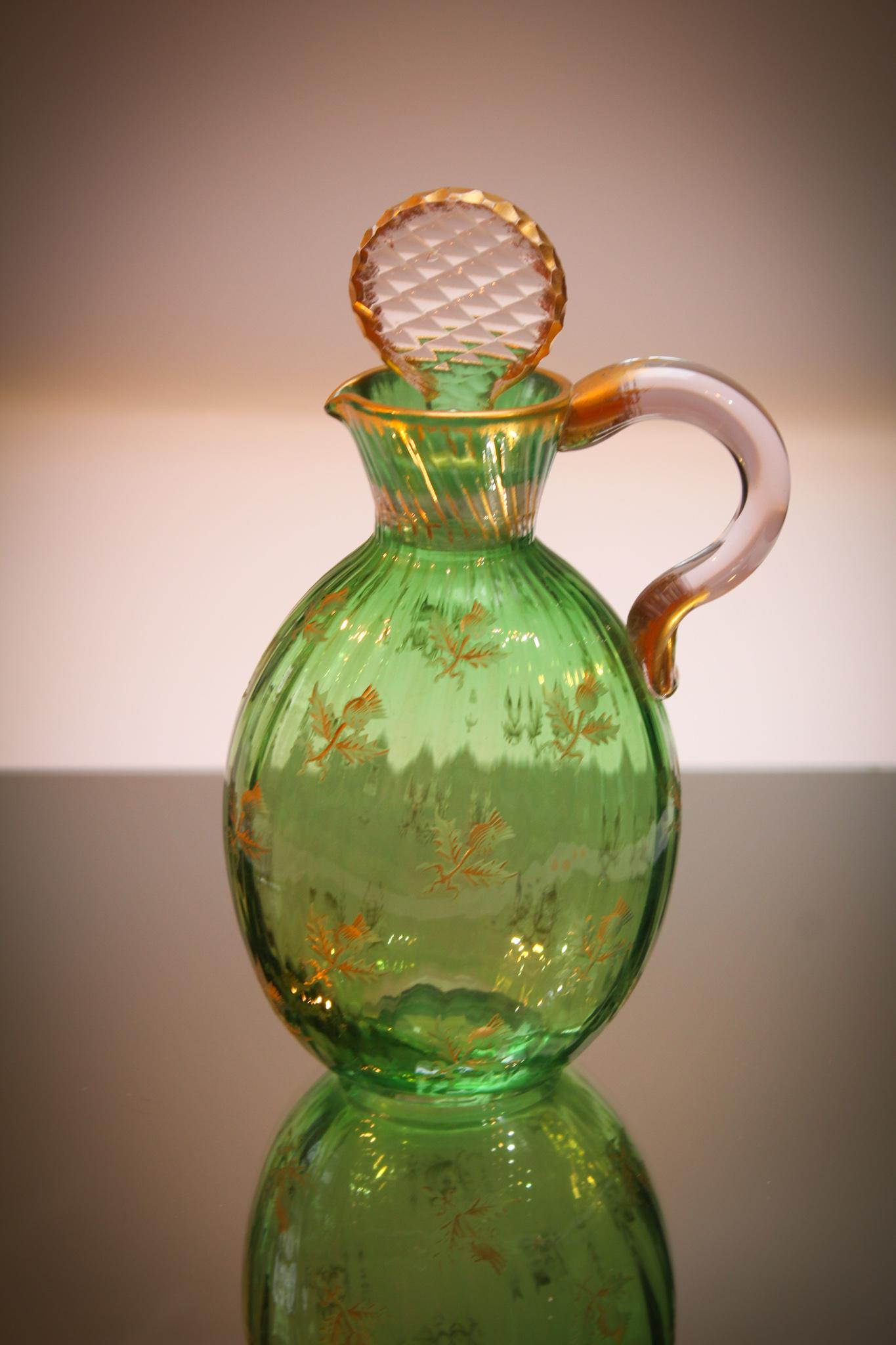 Daum Nancy Gilt Decorated Green Glass Cruet: Daum Nancy Green gilt decorated with etched thistles cruet. Cruet retains orginal stopper. Beautiful example. Measures 7 3/4" tall.