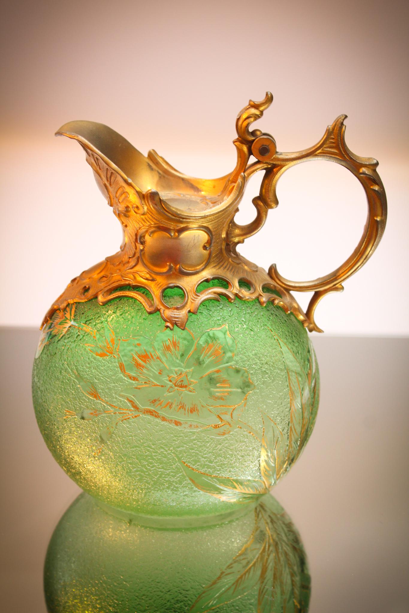Daum Nancy Cameo glass Green Claret Ormulu Mounts: Fabulous Daum Nancy cameo glass gilt decorated claret with original mounts. Piece is carved with floral decoration and gilt tracery and embellishments. So nice. It measures 6 3/4" tall.