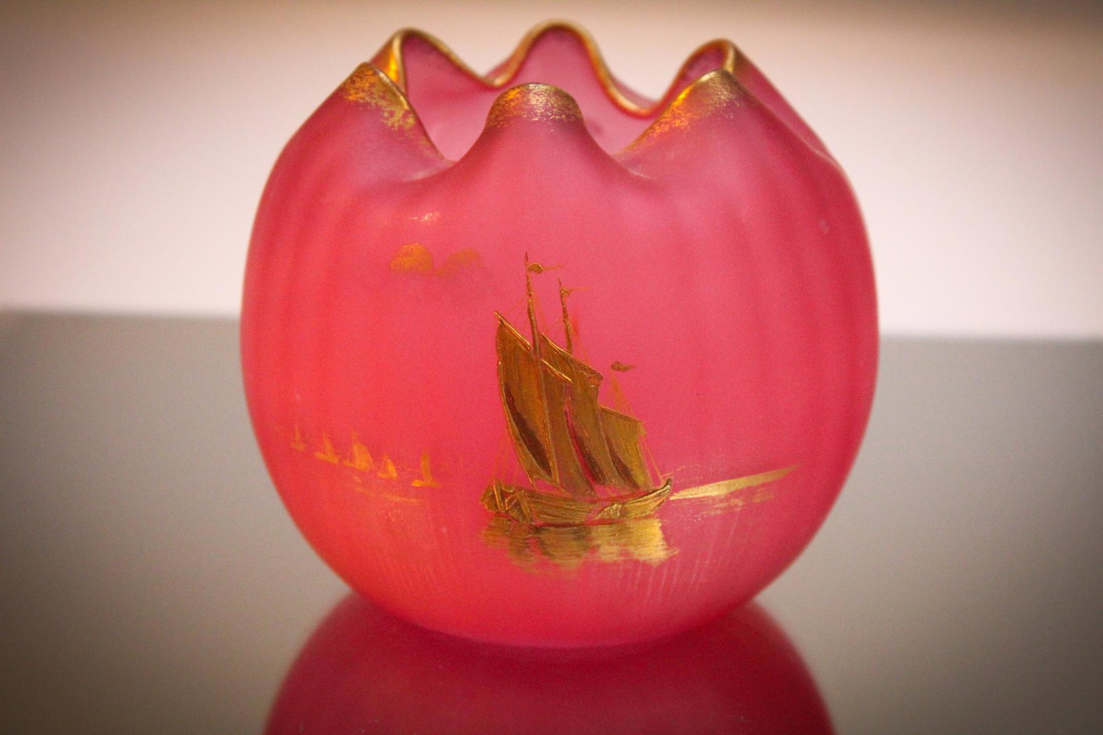 Mt. Joye Cranberry Satin Glass Gilt Rosebowl: Pretty in pink here. Deep pink that is. Rich cranberry satin glass attributed to Mt. Joye rosebowl with gilt dÃ©cor of sailboats and accents. Piece measures 4" tall. Don't let this one sail away.