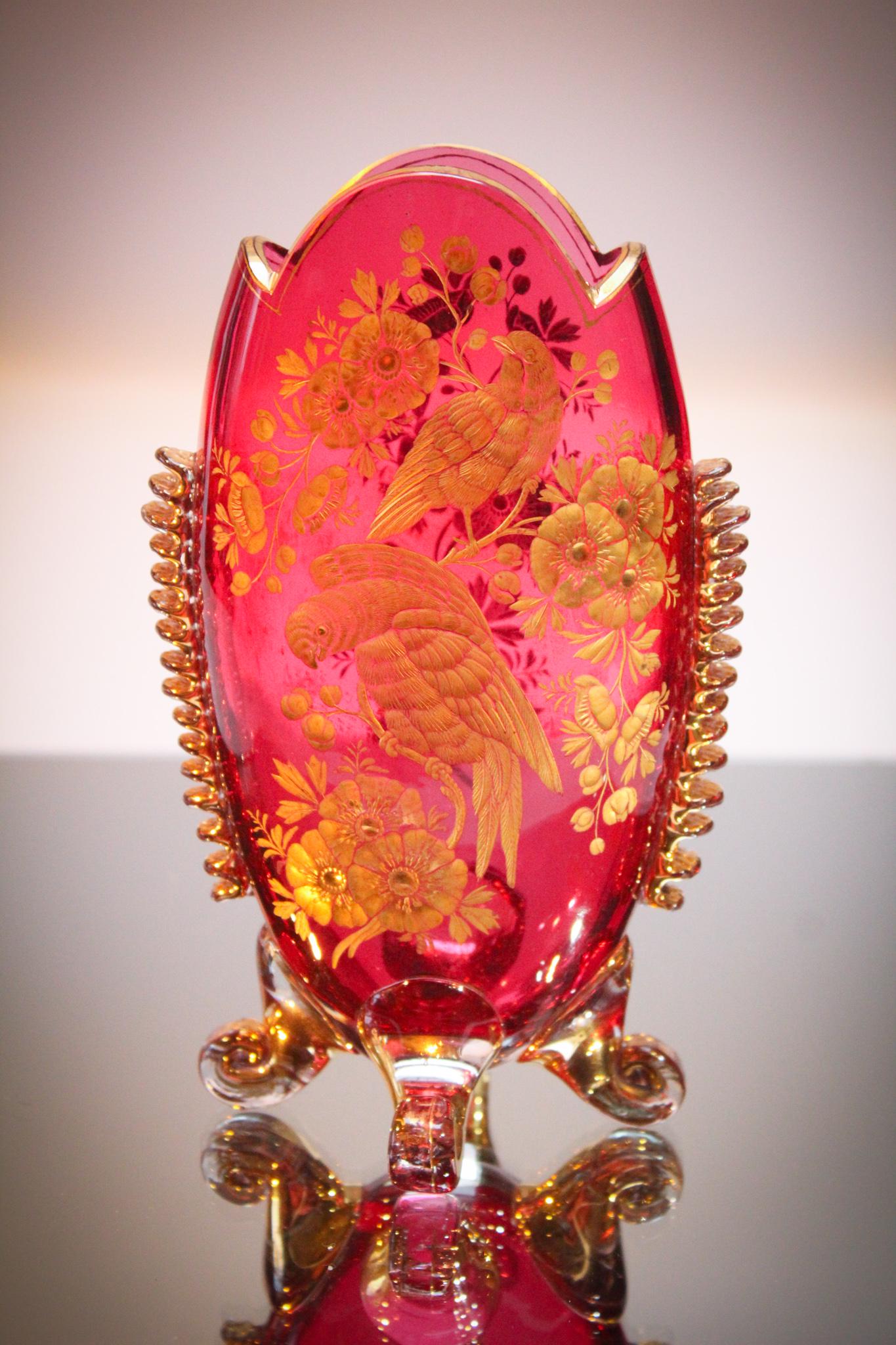 Moser Cranberry Gilt Engraved Pillow Vase: The detail on this charmer is so good. The piece is engraved and gilt decorated. Four applied feet and a tightly applied fan rigaree on the sides make this an outstanding example. Measures 7" tall.