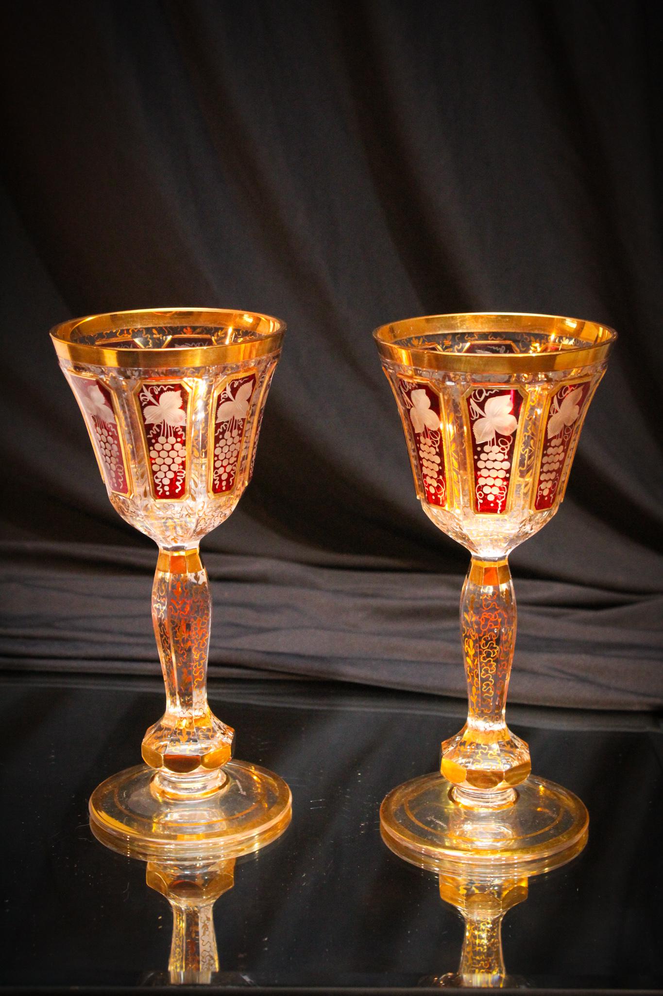 2 pc Lot Egermann Ruby Etched Gilt Goblets: Nice offering here of a matched pair of signed Bohemian Egermann gilt decorated and ruby embellished goblets. Richly enhanced with gilt tracery. Each measure 7 3/4" tall.