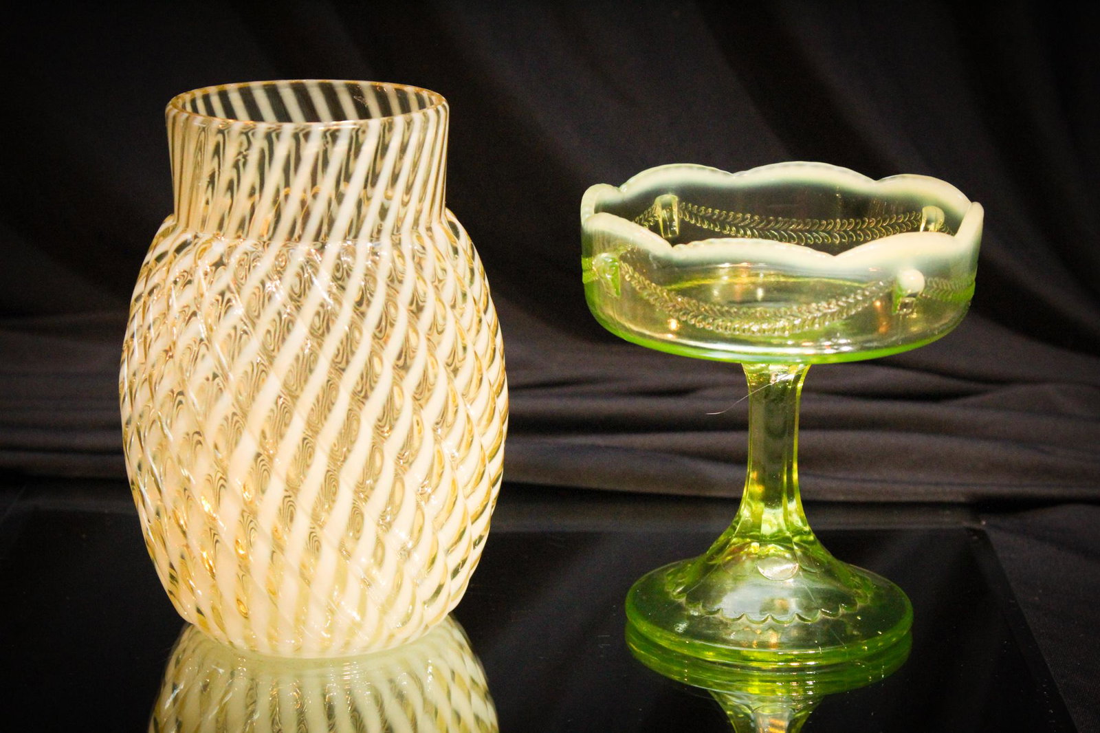 2 pc Lot Vaseline Opalescent Beaumont Jefferson Glass: Great offering of 2 pieces of vaseline opalescent glass. A reverse swirl Beaumont reverse swirl pattern celery vase and a Jefferson Swag with bracket jelly compote. Such bang for your buck. Tallest me