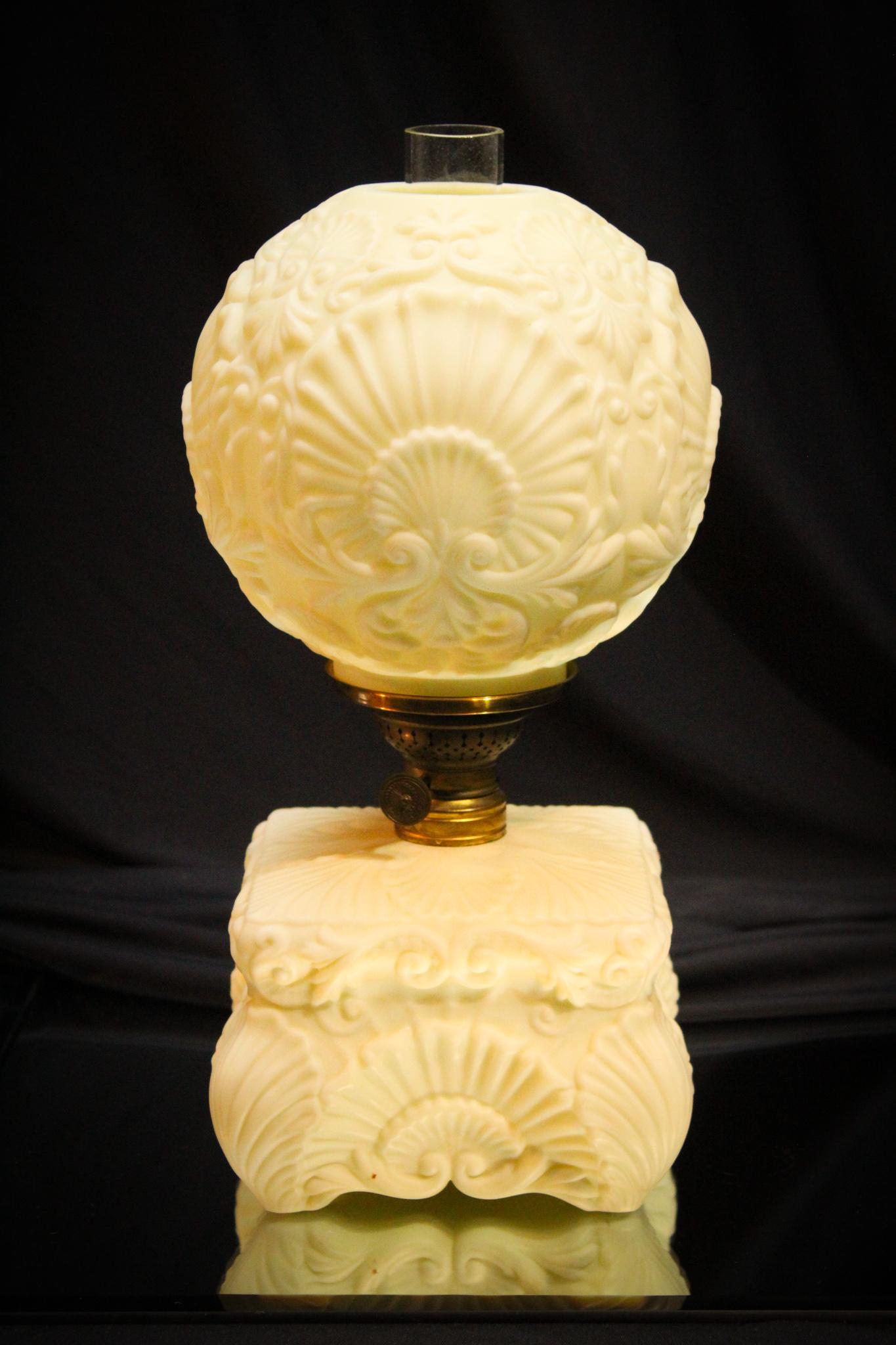 Custard Uranium Glass Victorian Jr. Oil Lamp: Folks, this one is wonderful lamp. Look at the embossed shell pattern and the fine detail in the mold. We are pleased to offer this lamp. We cannot remember selling one before. Measures 12" tall.