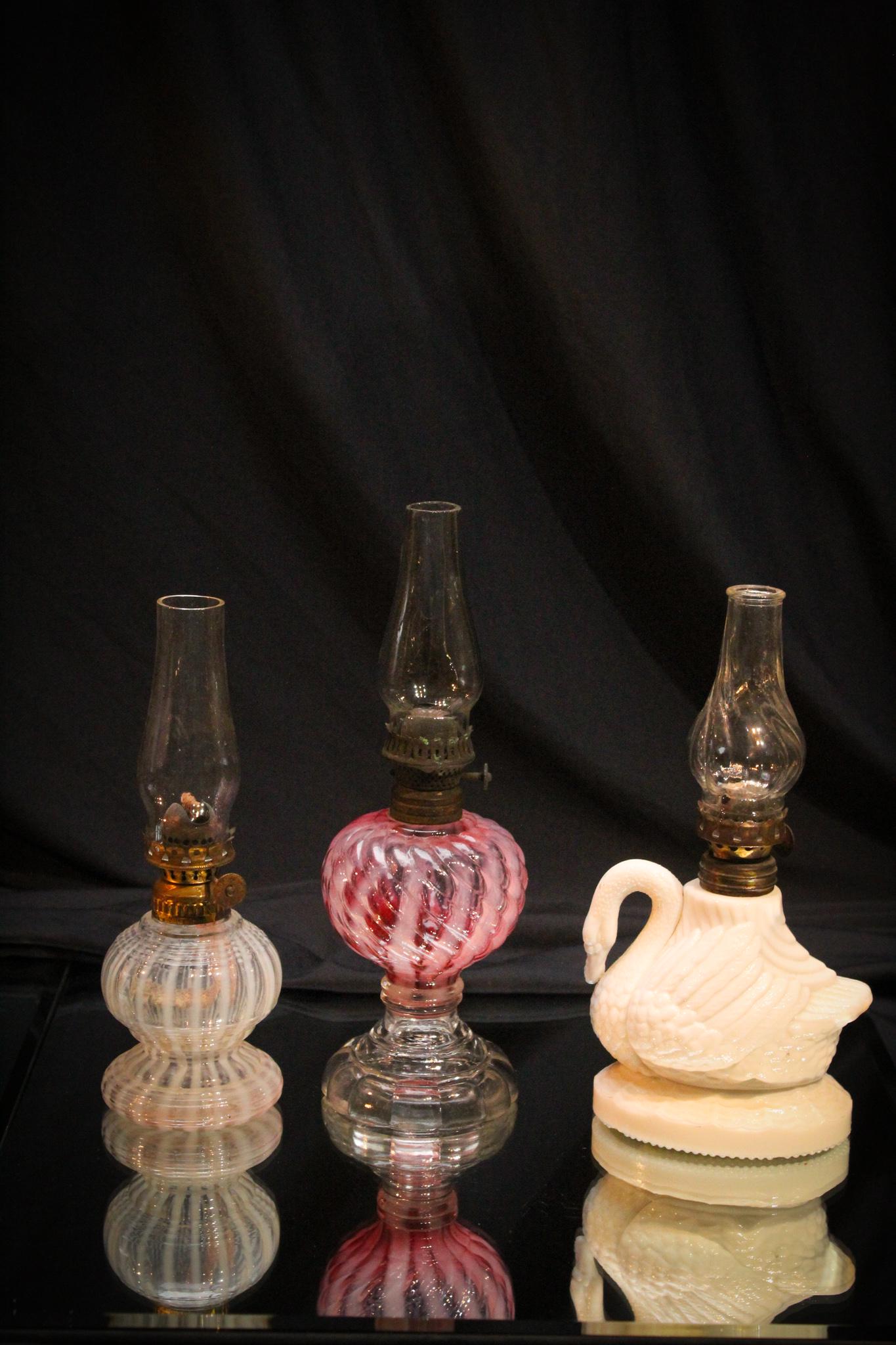 3 pc Lot Victorian Opalescent Atterbury Miniature Oil: Another lot with a lot of bang for your buck folks! This three piece lot of Victorian Miniature Oil lamps. An opalescent stripe base, a cranberry reverse swirl pedestal base, and an atterbury swan. Ni