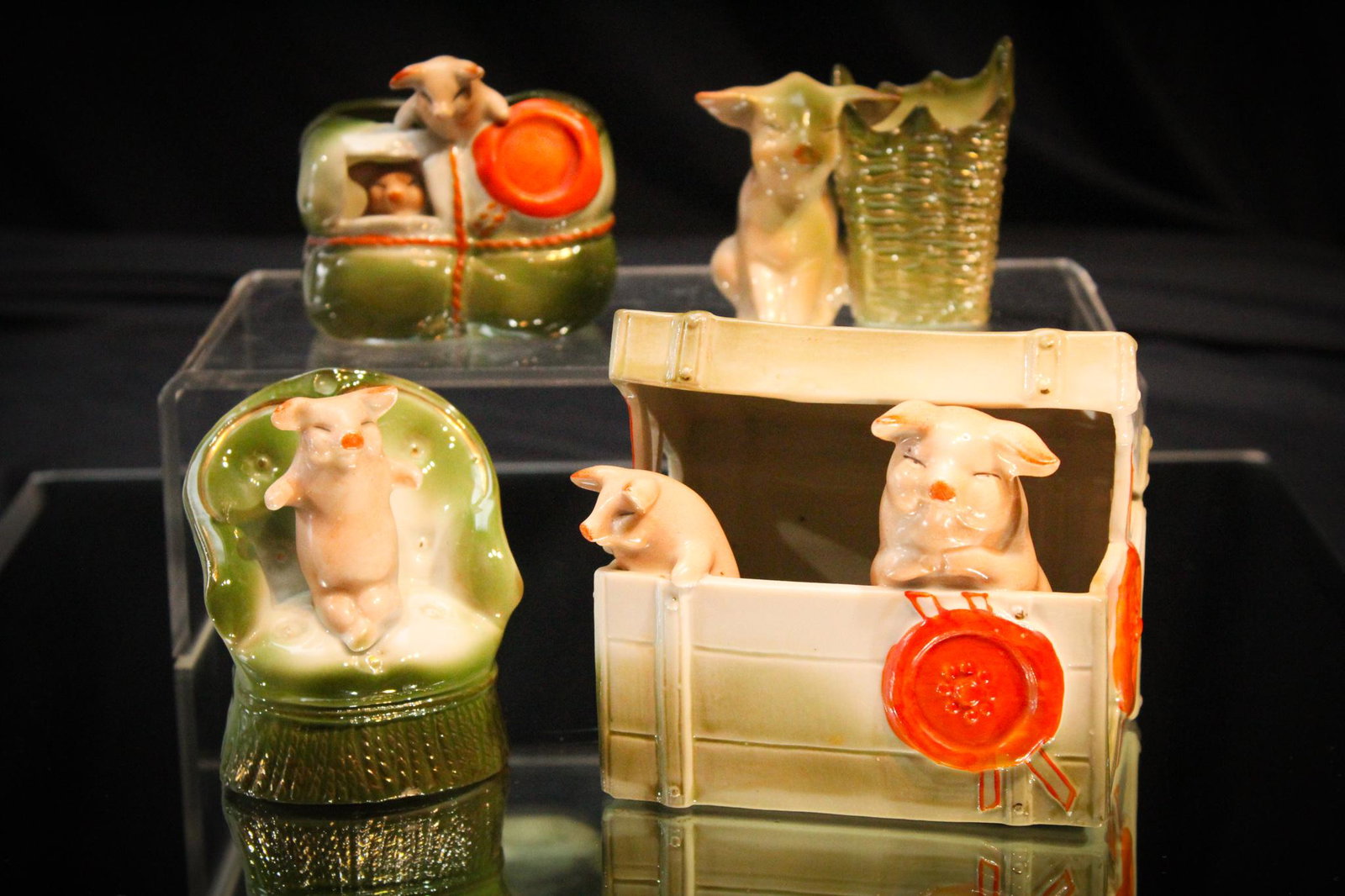 4 pc Lot German Pink Figural Pigs: Here are four hams. One with a steamer trunk, one with a chair, one with a basket, and the last all tied up. Tallest measures 3 3/4"
