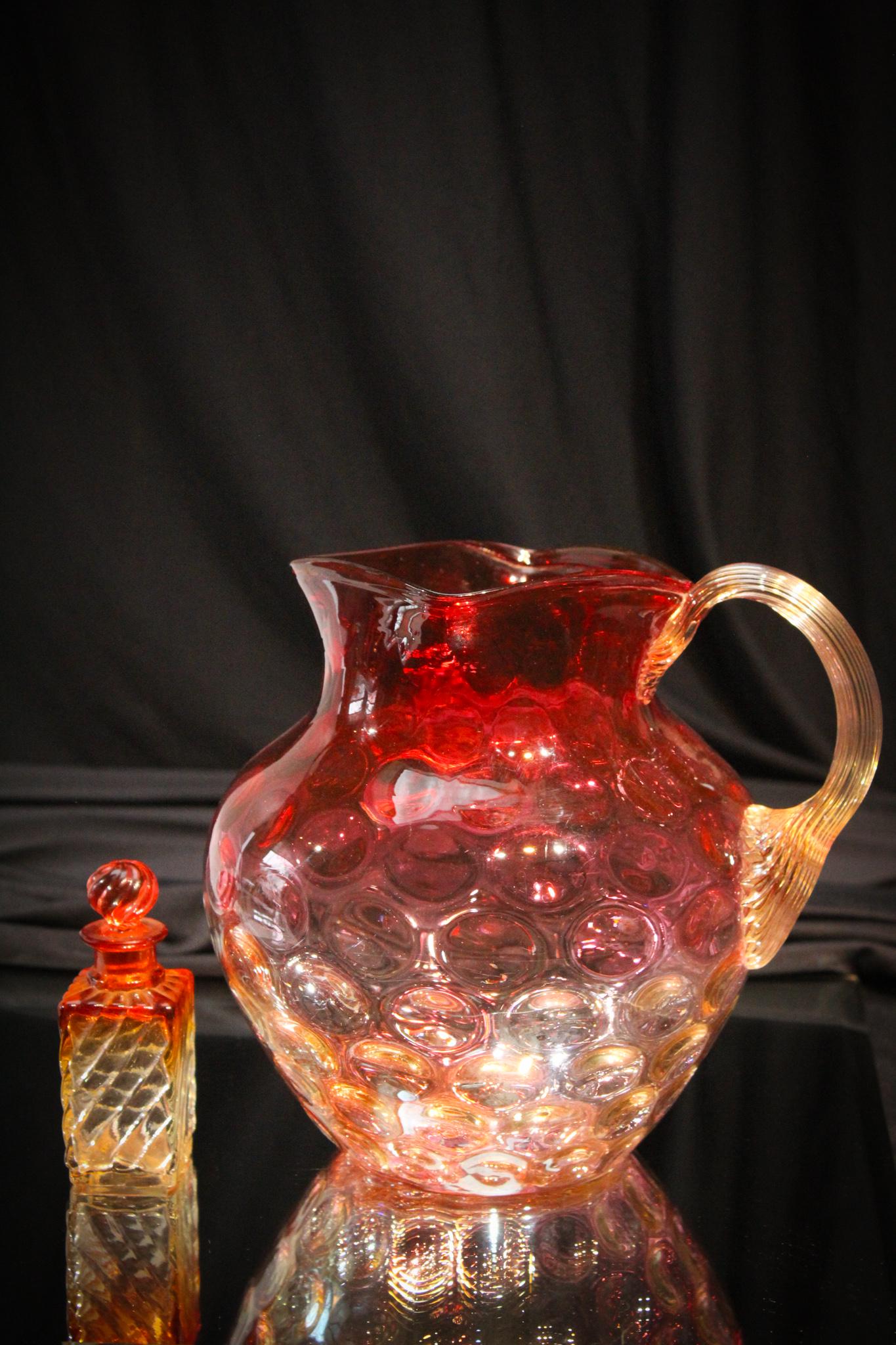 Victorian Amberina Glass Pitcher Rose Tiente Perfume: Attributed to Phoenix glass, we have paired this pitcher with another piece of amberina. A diminutive Baccarat Perfume bottle. Tallest measures 7 3/4" tall.