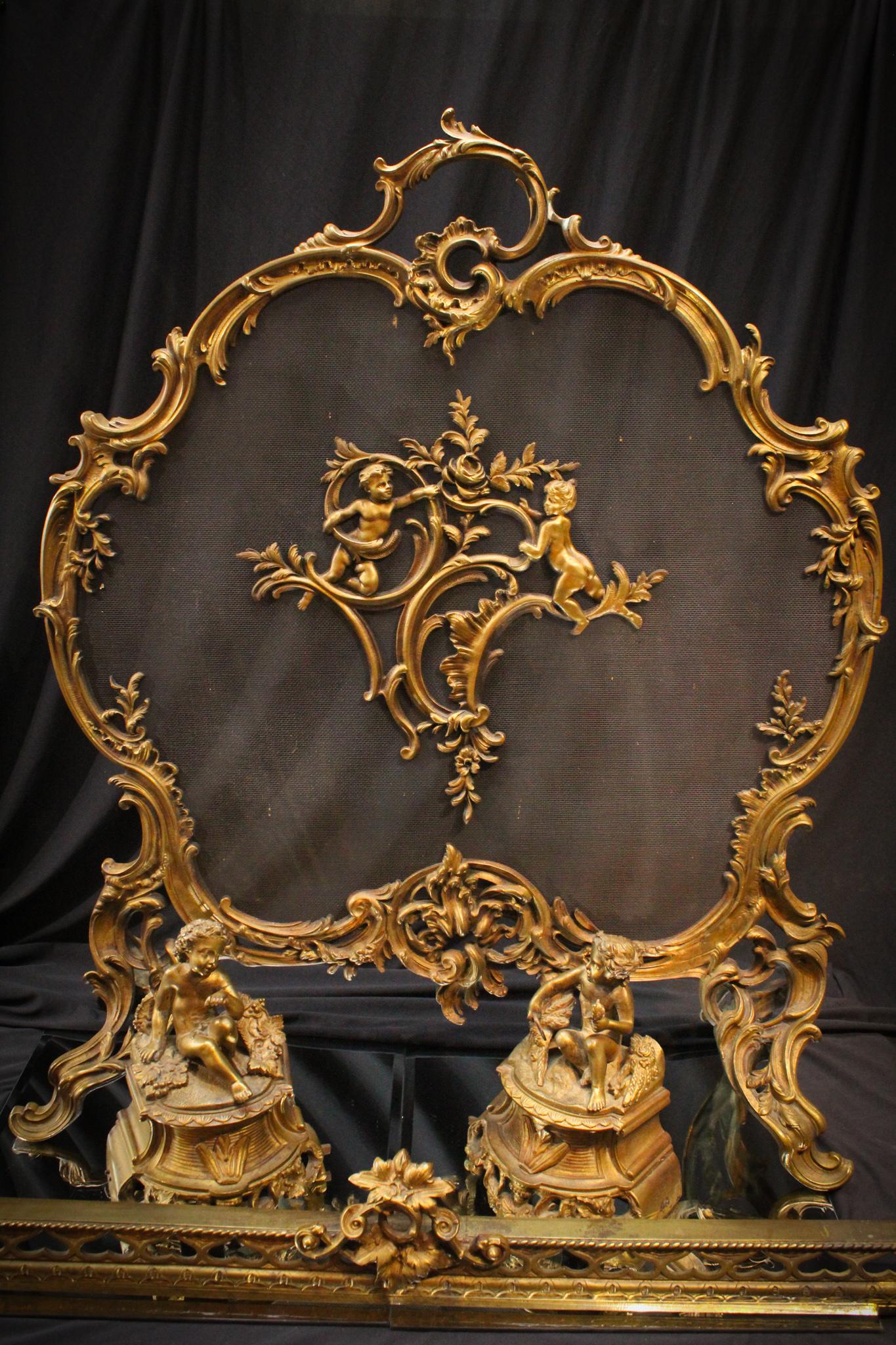 Cherub and Roccoco Turn of the Century Fireplace screen: Beautiful Cherub Roccoco designed turn of the century firplace screen and andirons. Heavy cast metal. Great detail. Measures 30" tall and 27" wide.