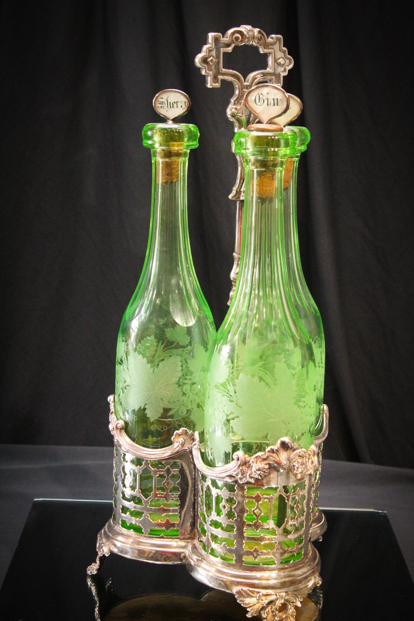Vaseline Green Etched Glass Tantalus in silverplate: This is such a special set. You don't see many like this tantalus. Etched green vaseline glass bottles set in original silverplate holder. Stoppers are marked Port, Gin, and cherry. Etched with grape