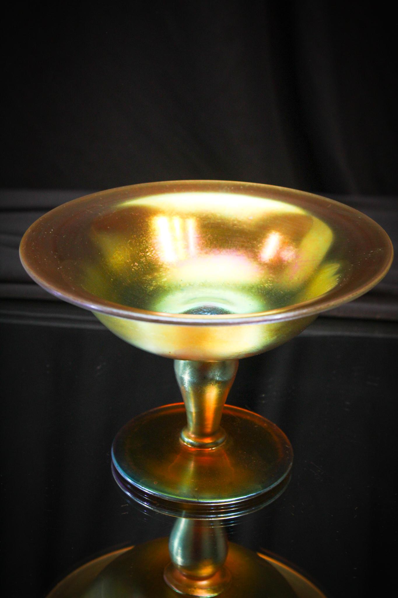 Steuben Glass Gold Aurene Compote: The color on this signed piece of Steuben gold aurene is phenomenal. Marked aurene #1983. Measures 6" diameter and 4" tall.