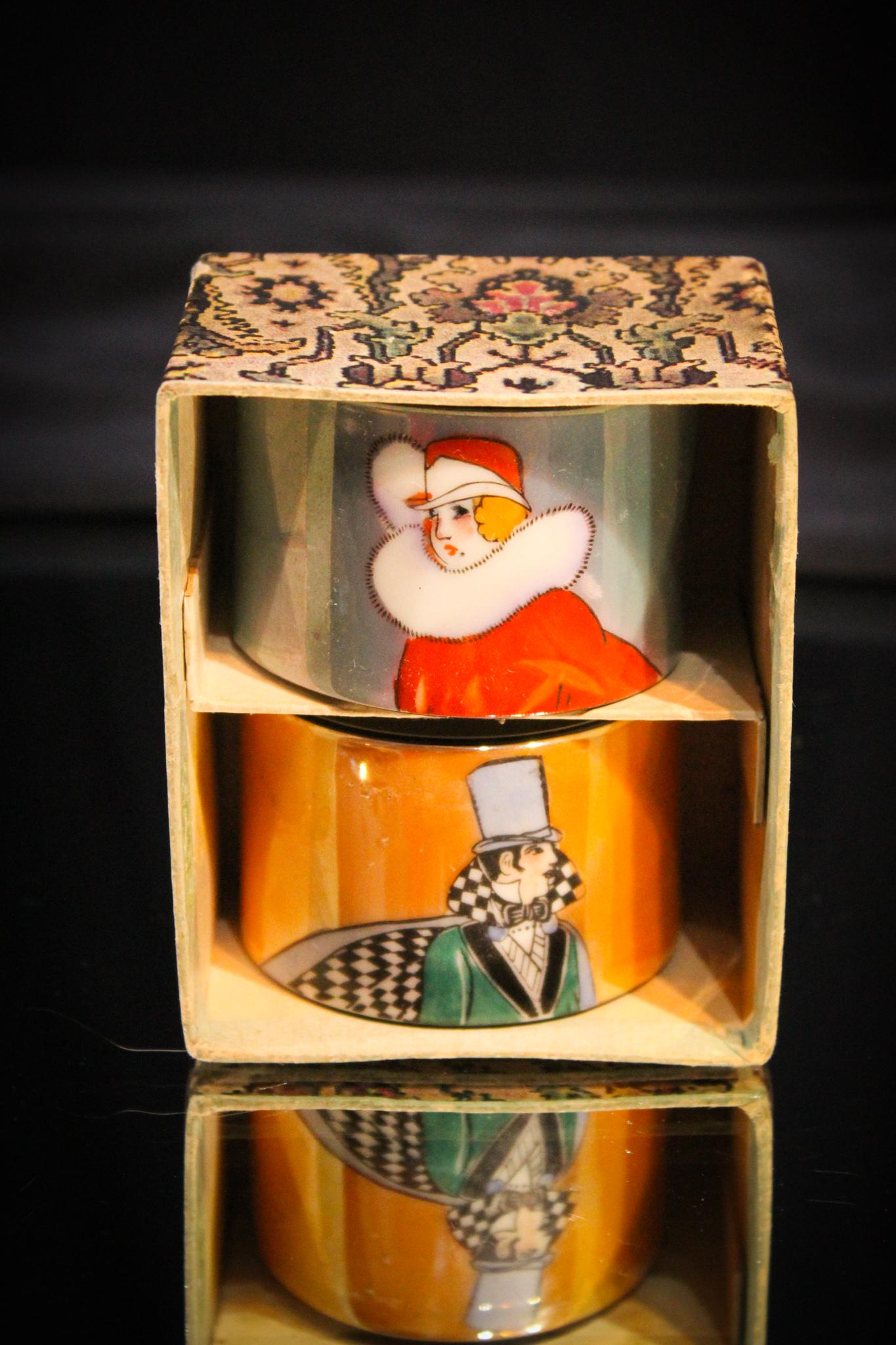 Noritake Art Deco Lustre finish Boxed Set Napkin rings: These are nice. How often do you find these let alone in the orignal box. Complete set of 2 napkin rings. Each measures 1 3/4" tall. Nice Art Deco design.