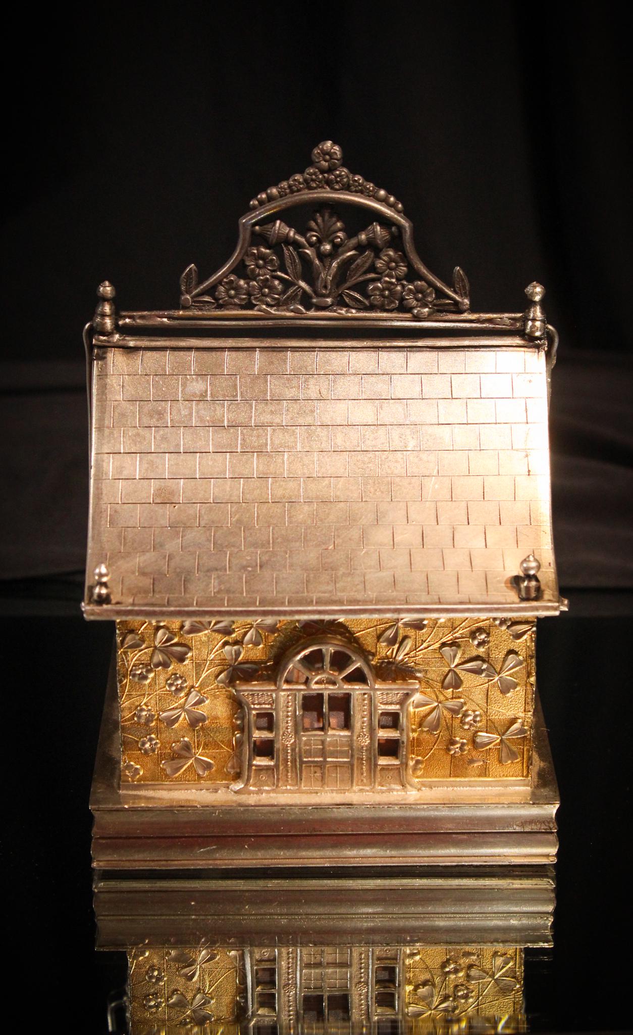 Hartford Victorian Silverplate Mechanical Jewelry: This is a most unusual jewelry casket from the Victorian era. Signed Hatford silverplate, this house is adorned with an abundance of clovers. Roof reclines to unveil the pink satin replaced fabric lin