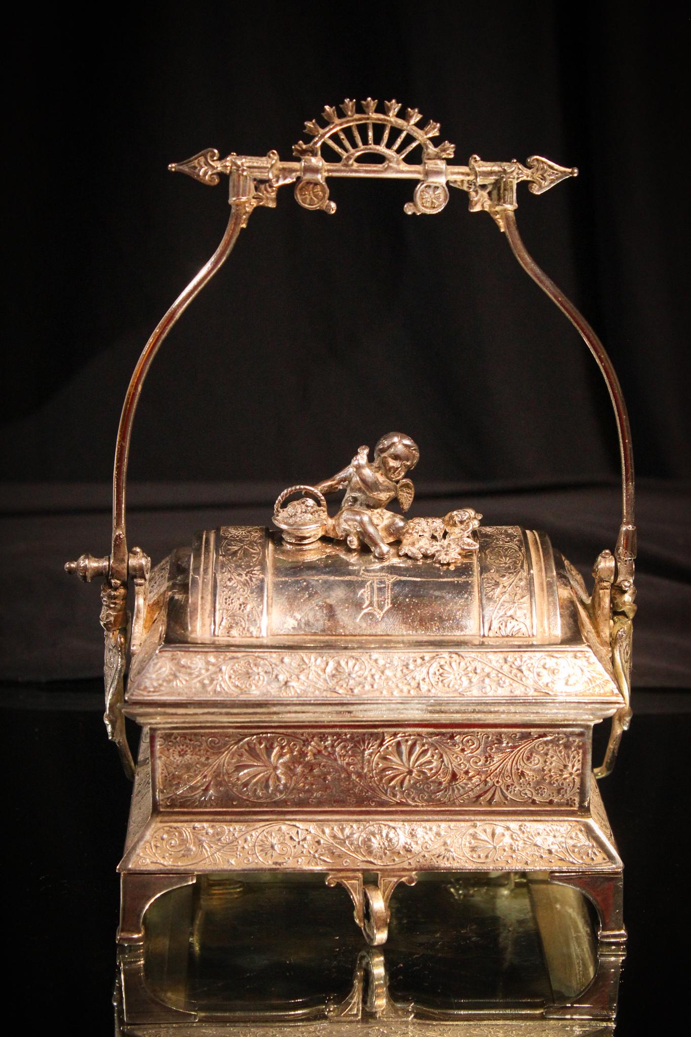 Victorian Silverplate Mechanical Jewery casket with: Very very nice signed Victorian silverplate jewelry casket. Handle pulls down to open the rolling drawer in the front. Very good condition and nice sized. Measures 9" tall.
