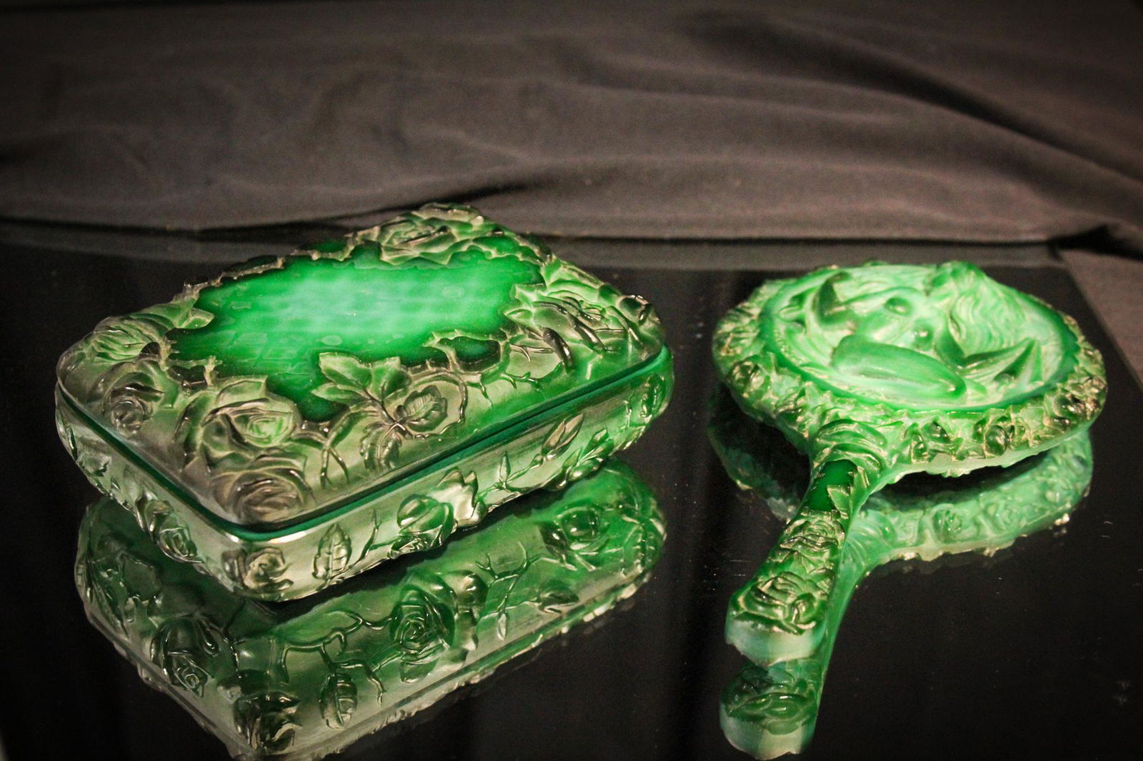 Art Deco Malachite Glass Dresser Box & Hand Mirror: We're offering two pieces together of this Art Deco malachite glass. One dresser box with lid and also a hand mirror. Box is decorated with roses while the hand mirror has a lady figure. Tallest measu