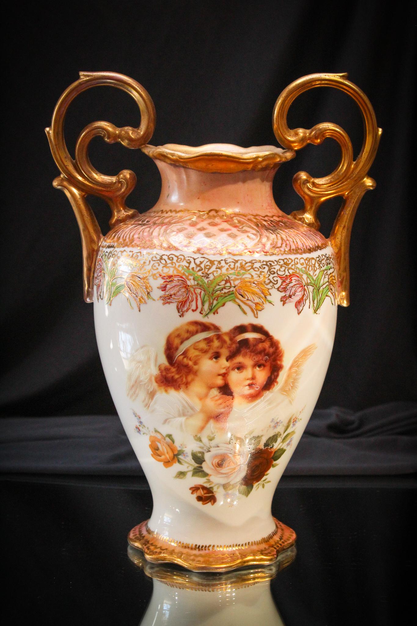 Bavarian Porcelain Angel and Floral Decor DBL Handle: Look at the handles on this vase. So stylish. Signed Bavarian Porcelan vase with angels and florals dÃ©cor. Measures 12" tall. Impressive.