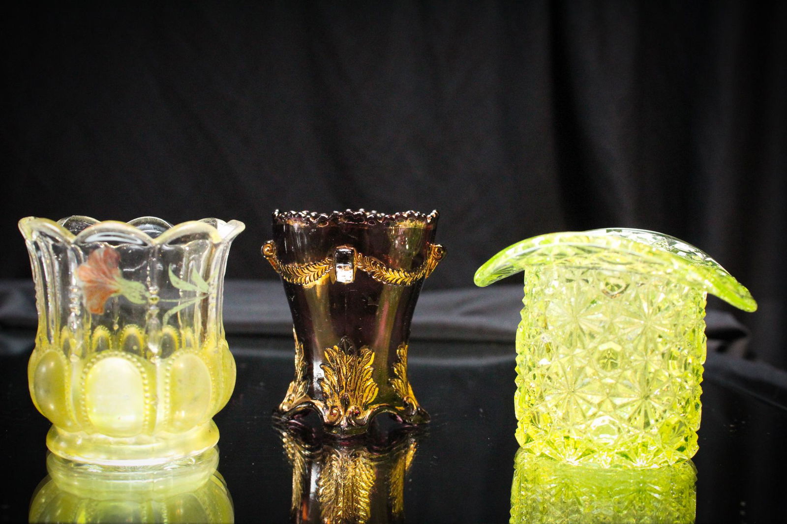 3 pc Lot Victorian Glass Toothpick Holders: Nice lot of 3 Victorian toothpick holders here. A amythest swag with bracket, a Michigan decorated, and a vaseliine daisy and button hat.