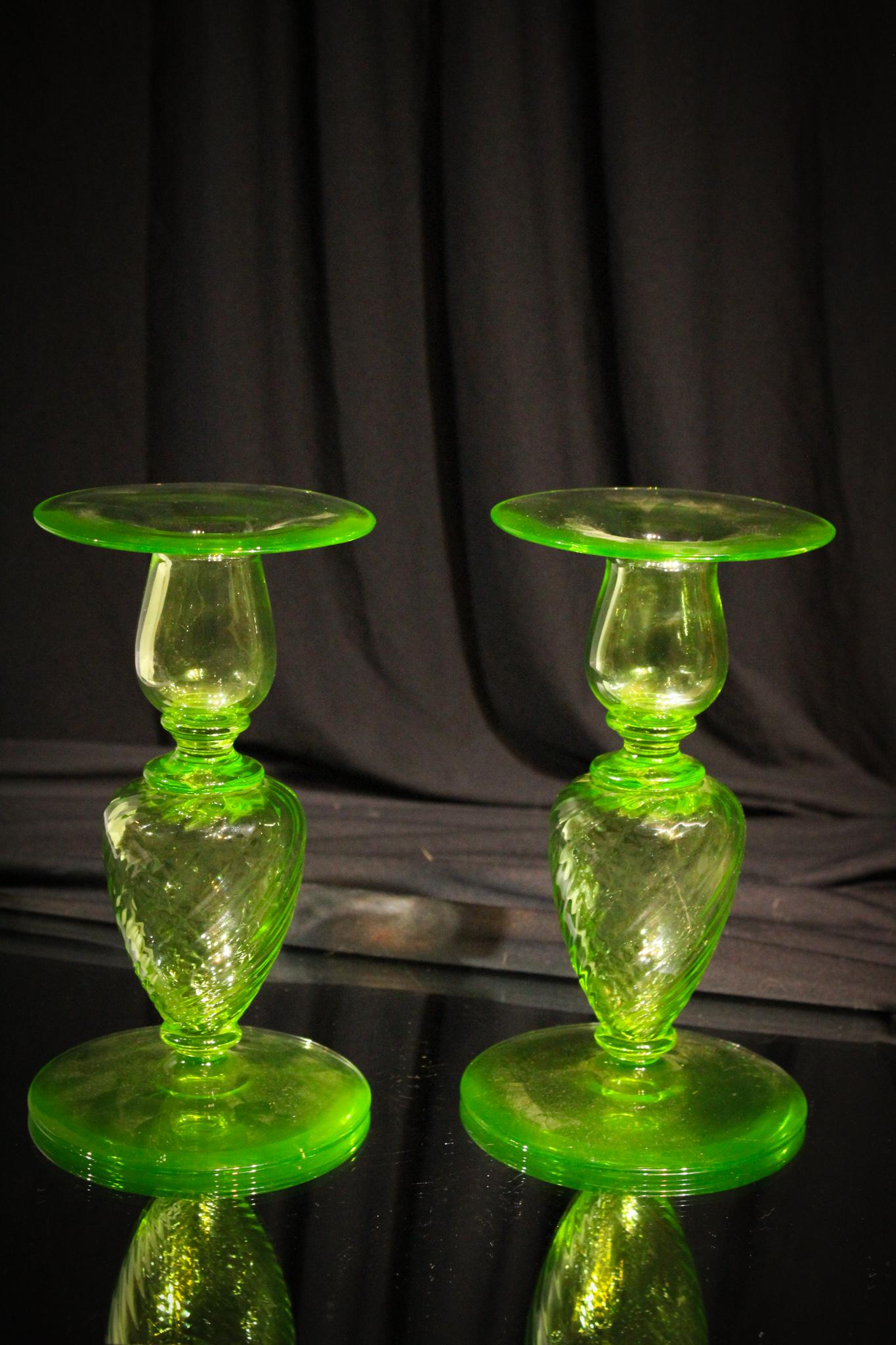 Pair of Antique Art Glass Steuben Era Candlesticks: Pair of antique green candlesticks in the likeness and period of Steuben. Unsure of the maker but well made and beautiful. Each measures 7 1/4" tall.