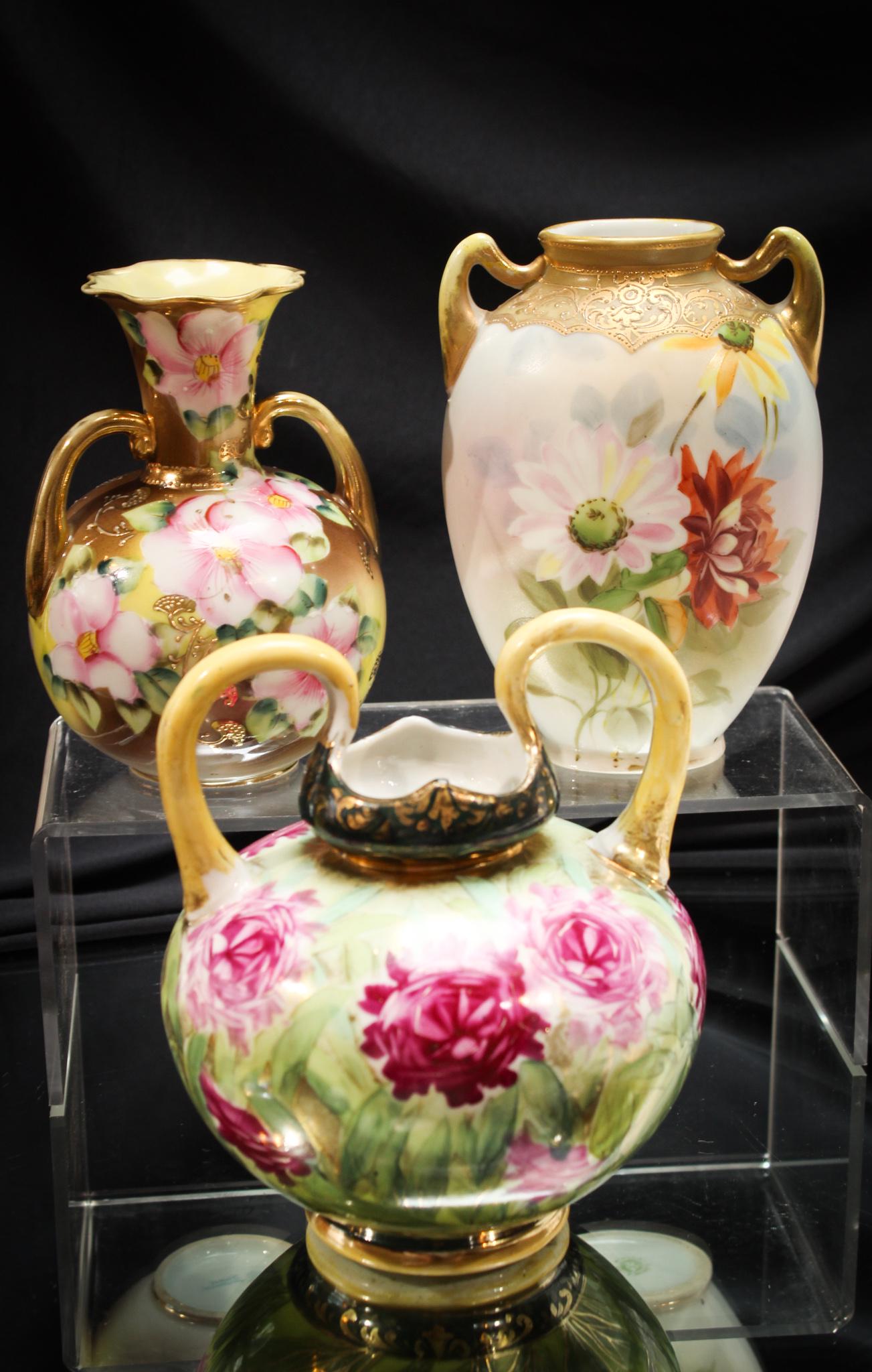 3 pc Lot Nippon Floral & Gilt Vases: Fit for a queen, these lovely Nippon vases are intricately decorated with florals and an abundance of gold. Signed as shown. Tallest measures 6 1/4" tall.