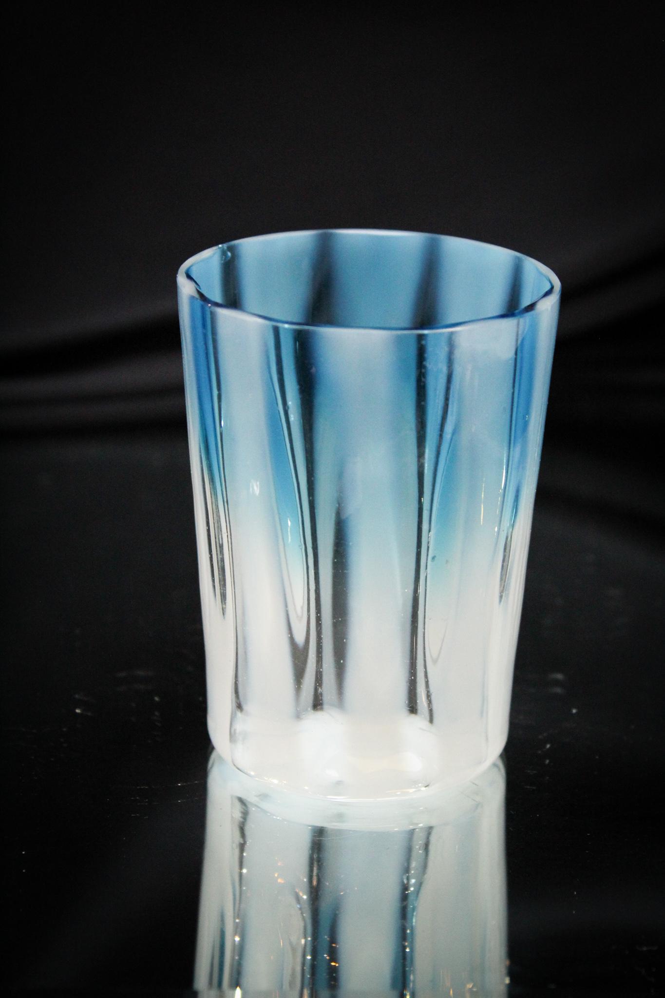 Scarce Bluerina Opalescent Stripe Tumbler: Great tumbler and seldom found. This example of bluerina fades from a wonderful blue to crystal and has the addition of wide opalescent stripes. Another gem from this consignor. Measures 3 3/4" tall.