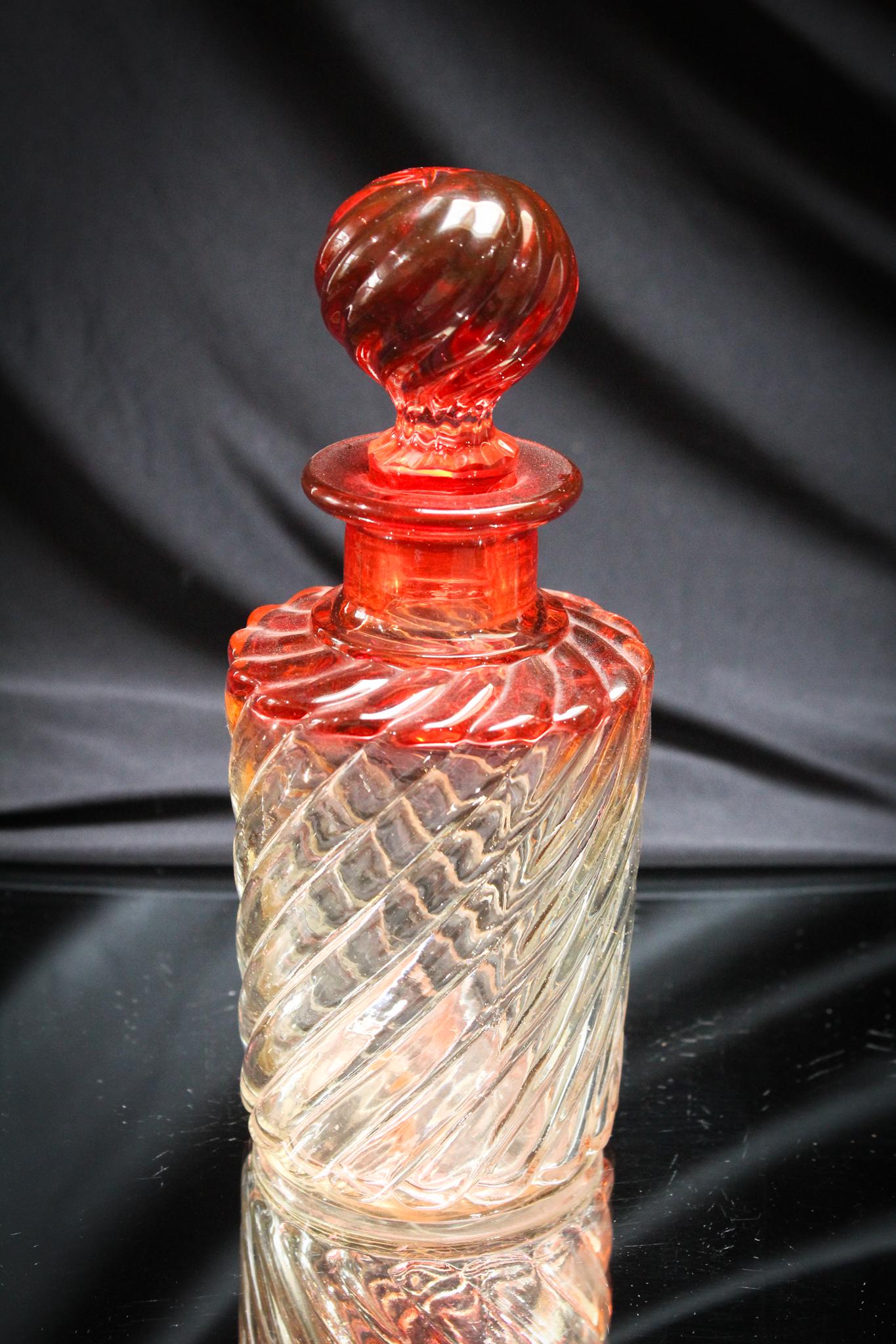 Baccarat Glass Rose Tiente 8" Cologne Bottle: Quite a nice Baccarat Rose Tiente Swirl pattern cologne bottle with matching stopper. Great color and clarity to the glass. Measures 8" tall.