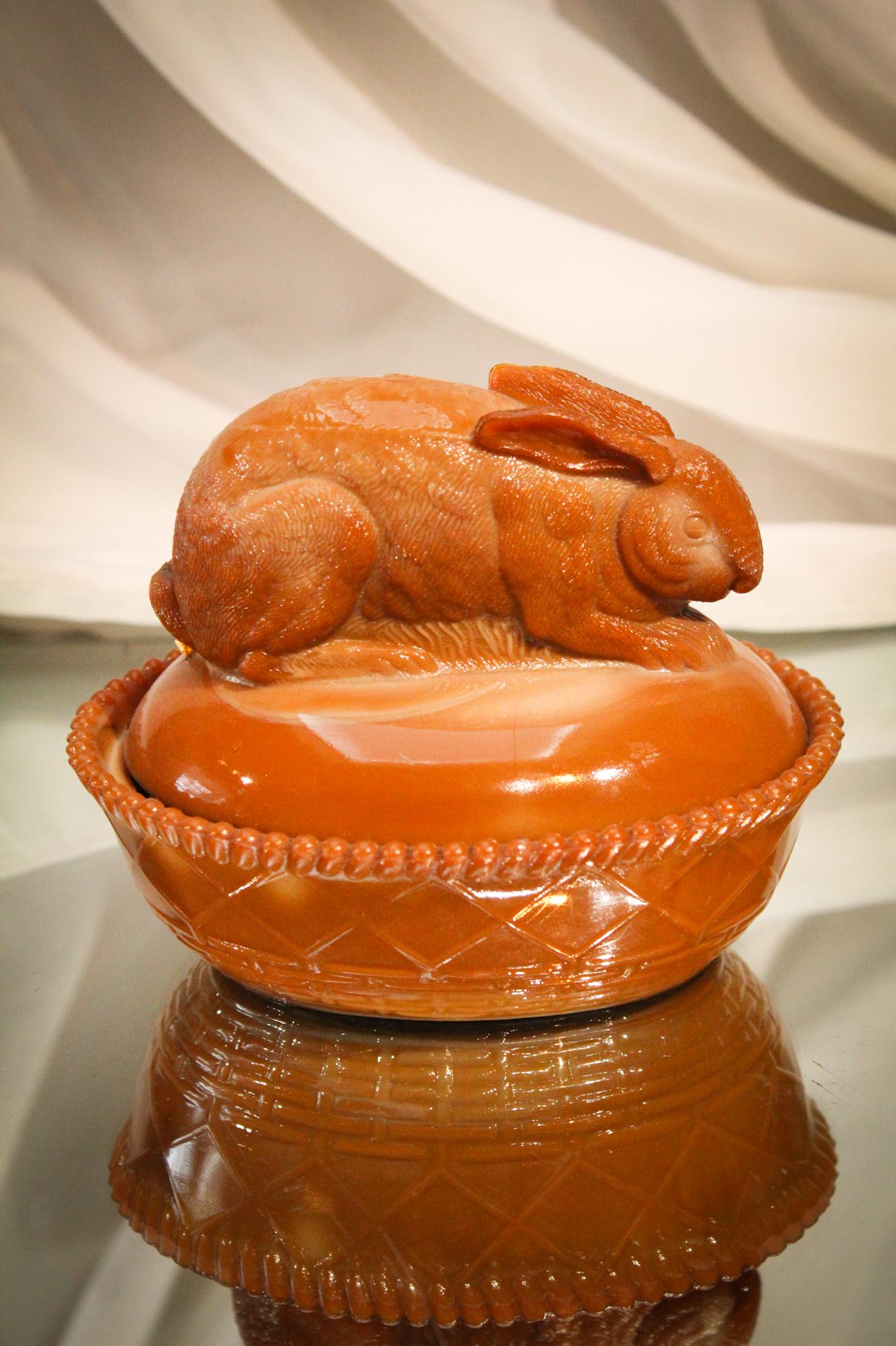 Greentown Glass Victorian Chocolate Rabbit on a Nest: What goes together better than chocolate and a bunny? Exactly. This little cutie is in Greentown Glass most popular chocolate glass. Measures 4" tall.