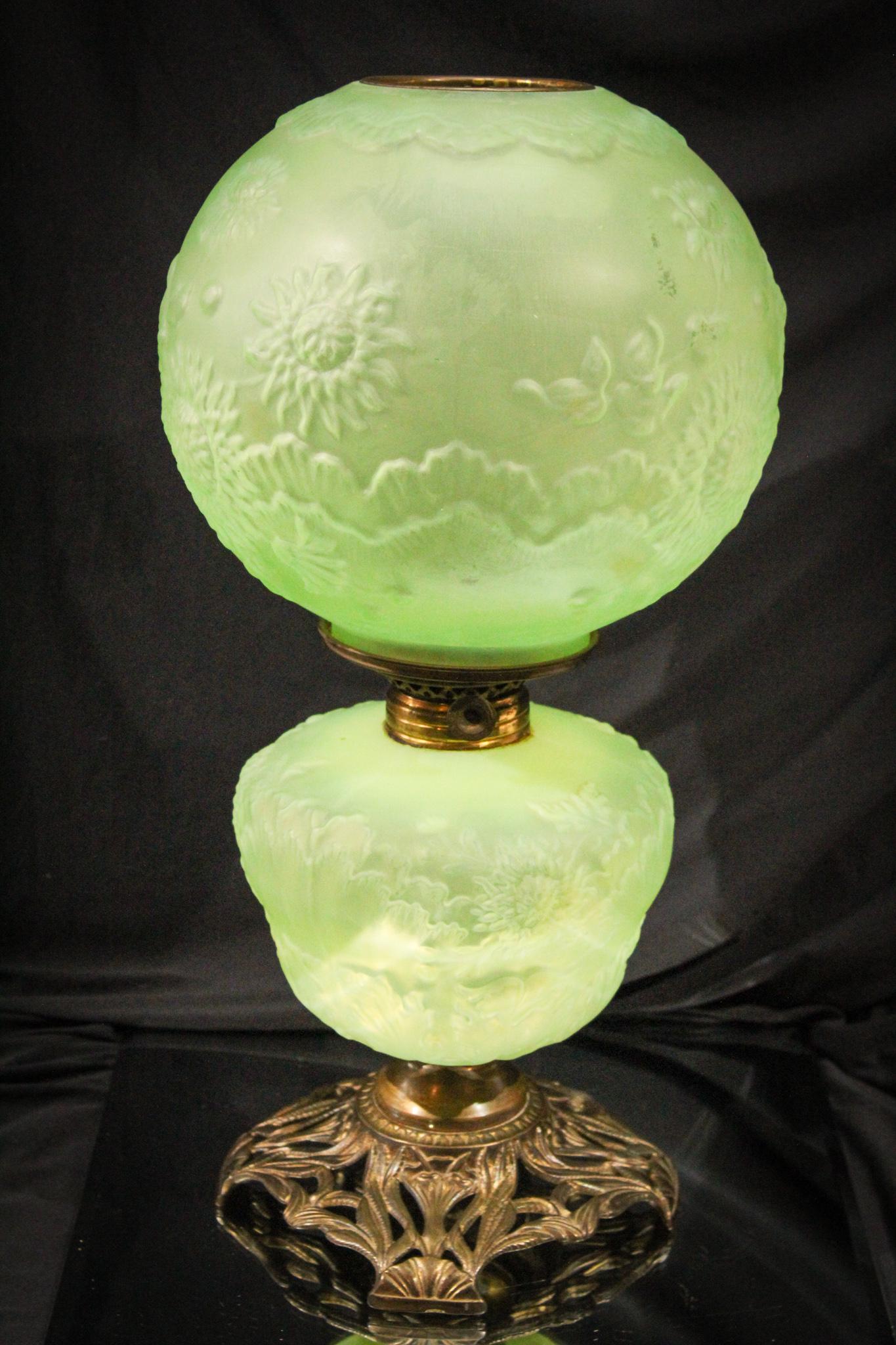 Green Satin Victorian Uranium Vaseline Roses Gone with the Wind Lamp: What a beautiful lamp. This lamp in frosted green satin is actually a vaseline glass that glows brilliantly under black light. It is embossed with roses and festoons. Very arrtractive. Measures 18 1/2