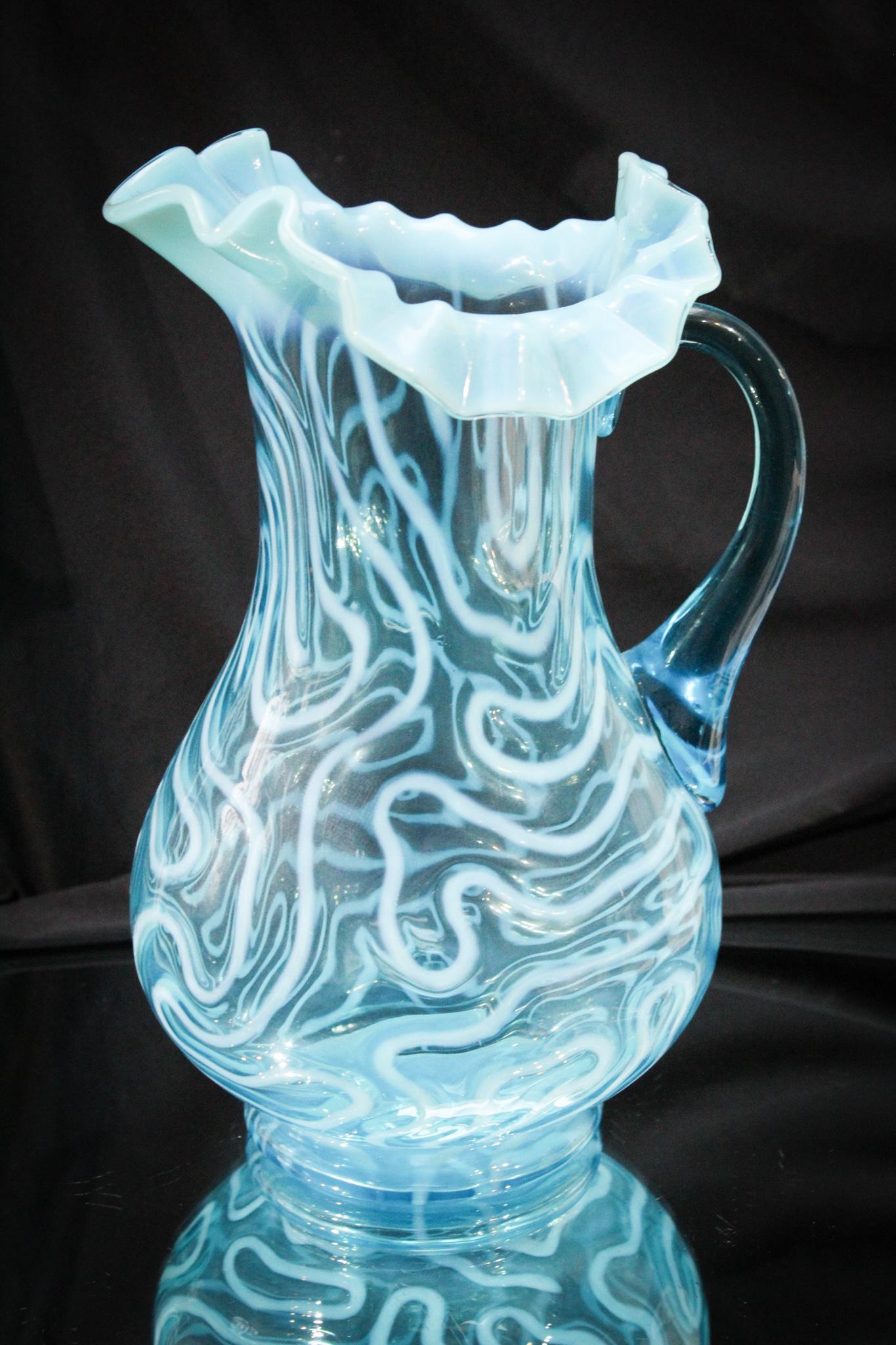 Scarce Blue Opalescent Victorian Swirling Maze Pitcher: Did you buy the green one? Well you have to have the blue one then. Right? Another nice example of the swirling maze pattern in blue. This one measures 10 3/4" tall.