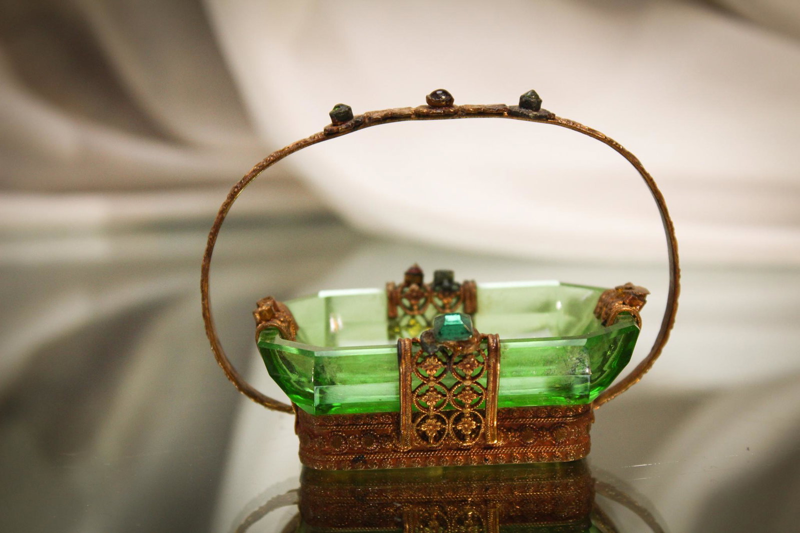 Emerald Intaglio Cut Open salt in Jeweled Frame: This open salt in deep emerald green has Wonderful intaglio cutting and folks, look at that frame. Wowza! So pretty. Entertain a queen with this one. Measures 2 1/2" tall.