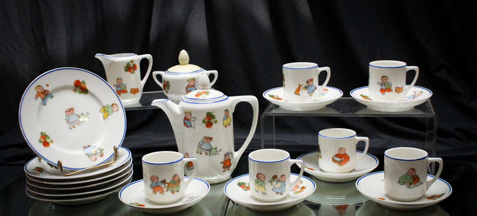 Victorian Rudolstadt 20 pc Pudgy Kids & Animals Child's Tea Set: Looks like the last thing these pudgy little kids and animals adorning this set need is sweet tea and dessert. LOL. Very nice set. Tallest piece measures 5 1/2" tall.