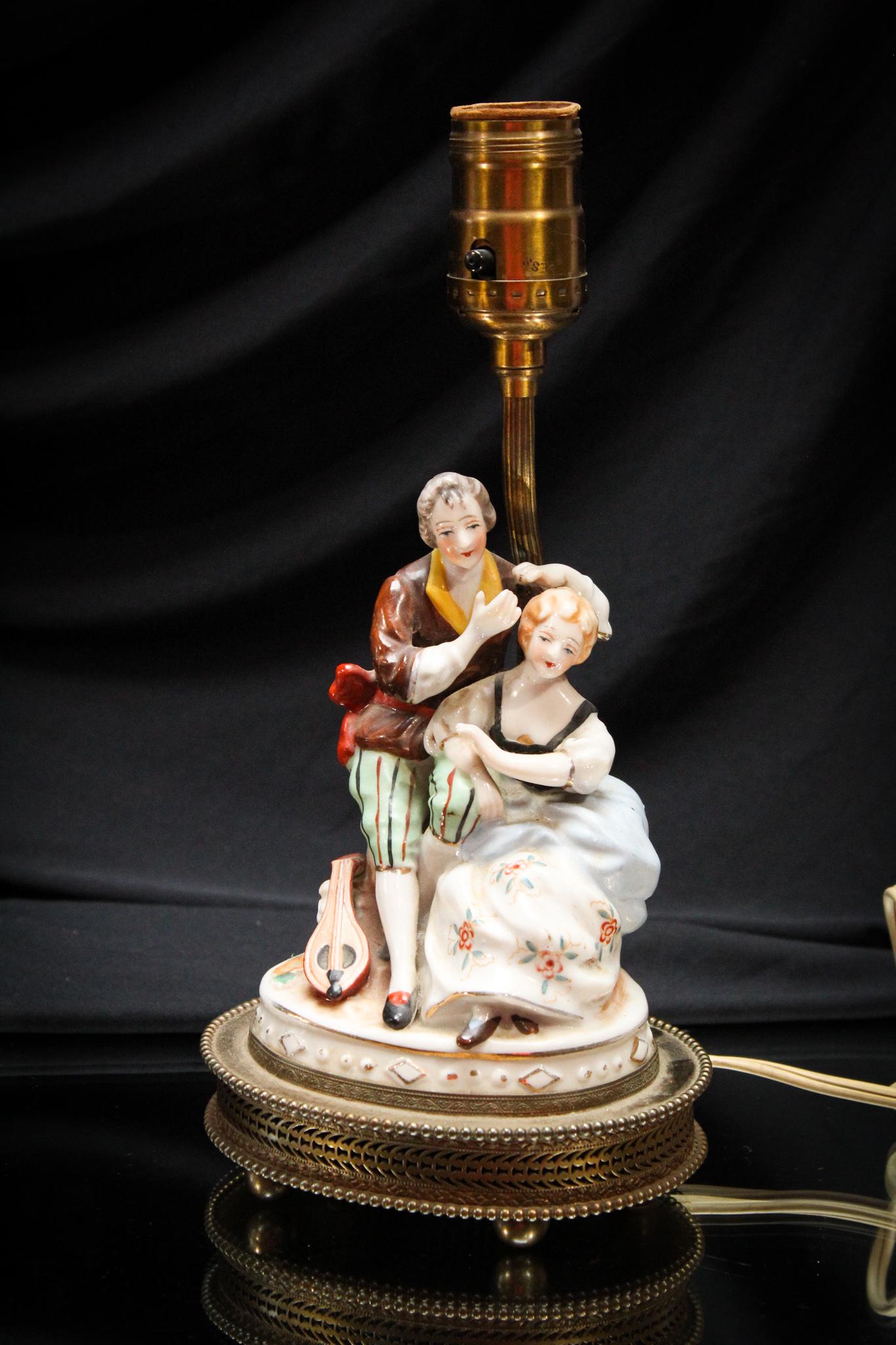 Antique Porcelain Courting Couple Boudoir Lamp: Charming boudoir lamp with porcelain figure on original mounts and hardware. High quality piece with the best detail. Measures 11" tall.