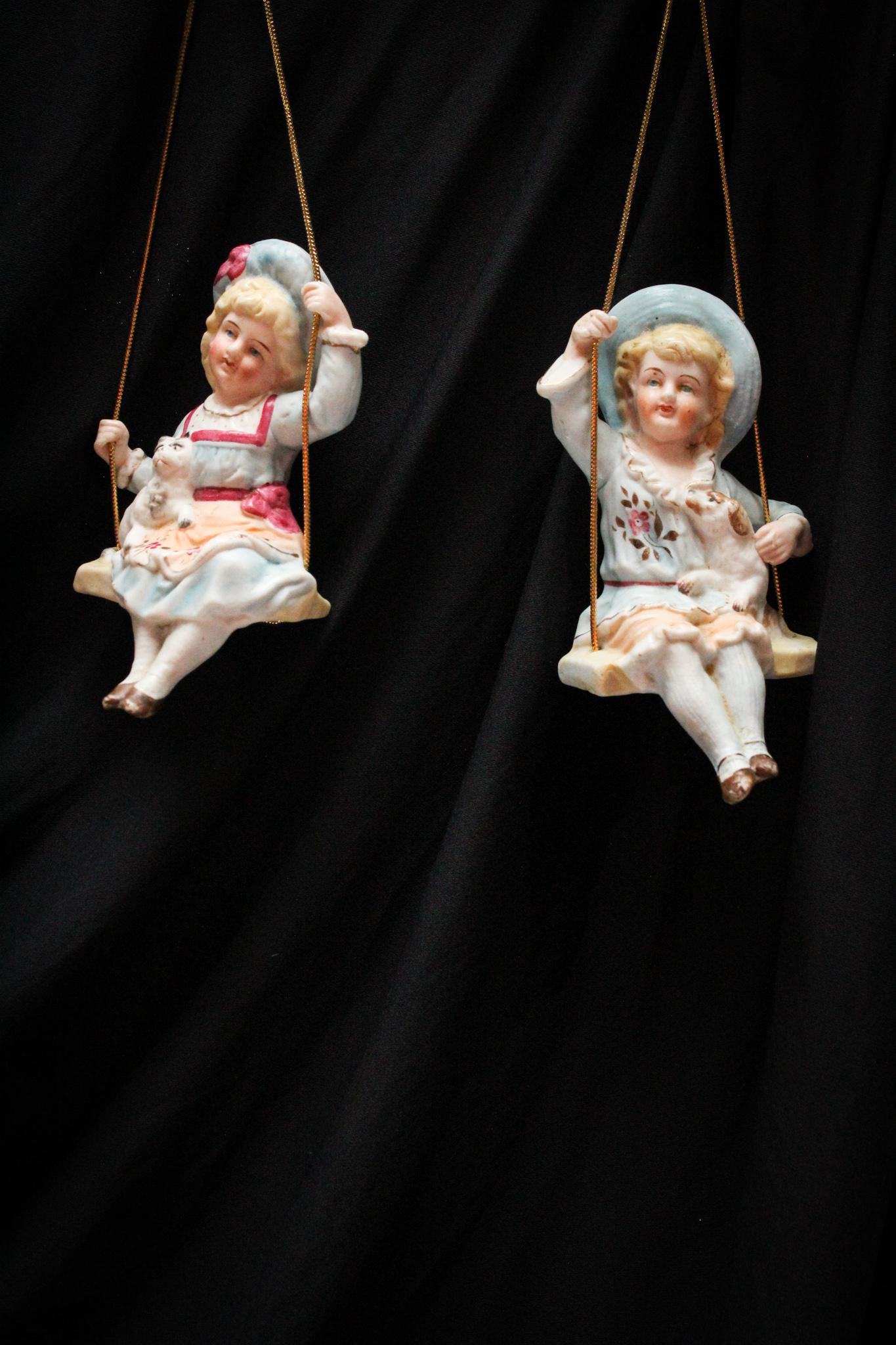 2 pc. Lot Victorian Bisque Porcelain Swinger: These kids are cute. That cat is not though. Take a look at the mug on that feline. Whew.. The artist needed more training with pussy cat faces, that's for sure. Measures 5 1/2".