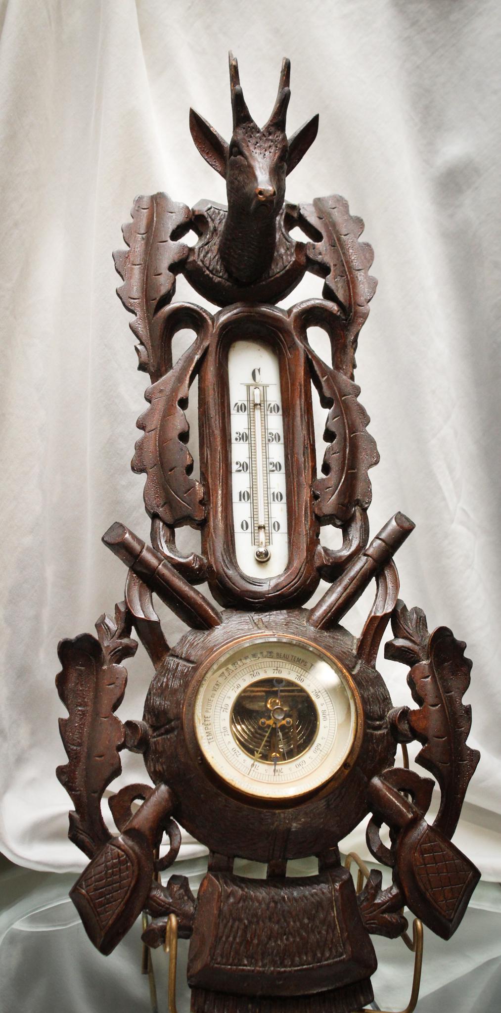 Victorian Black Forest Walnut Thermometer Stag: Fantastic and seldom-found Victorian Black Forest Stag Head thermometer. Piece is embellished with oak leaves, stag head, rifles, and hunting bag. Original finish. Super piece! Measures 21" long by 8 