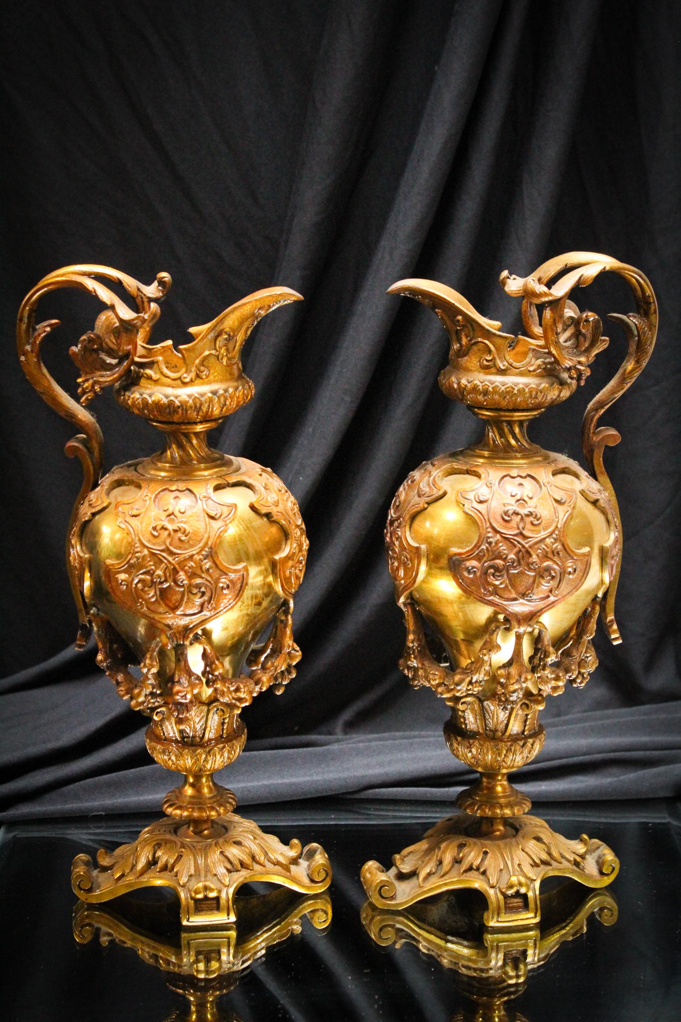 Pair Continental Neoclassical Brass Mantle Ewers: Beautiful pair of Continental Victorian ornate brass mantle ewers. Greatly detailed elaborate pieces. Each measures 11" tall.