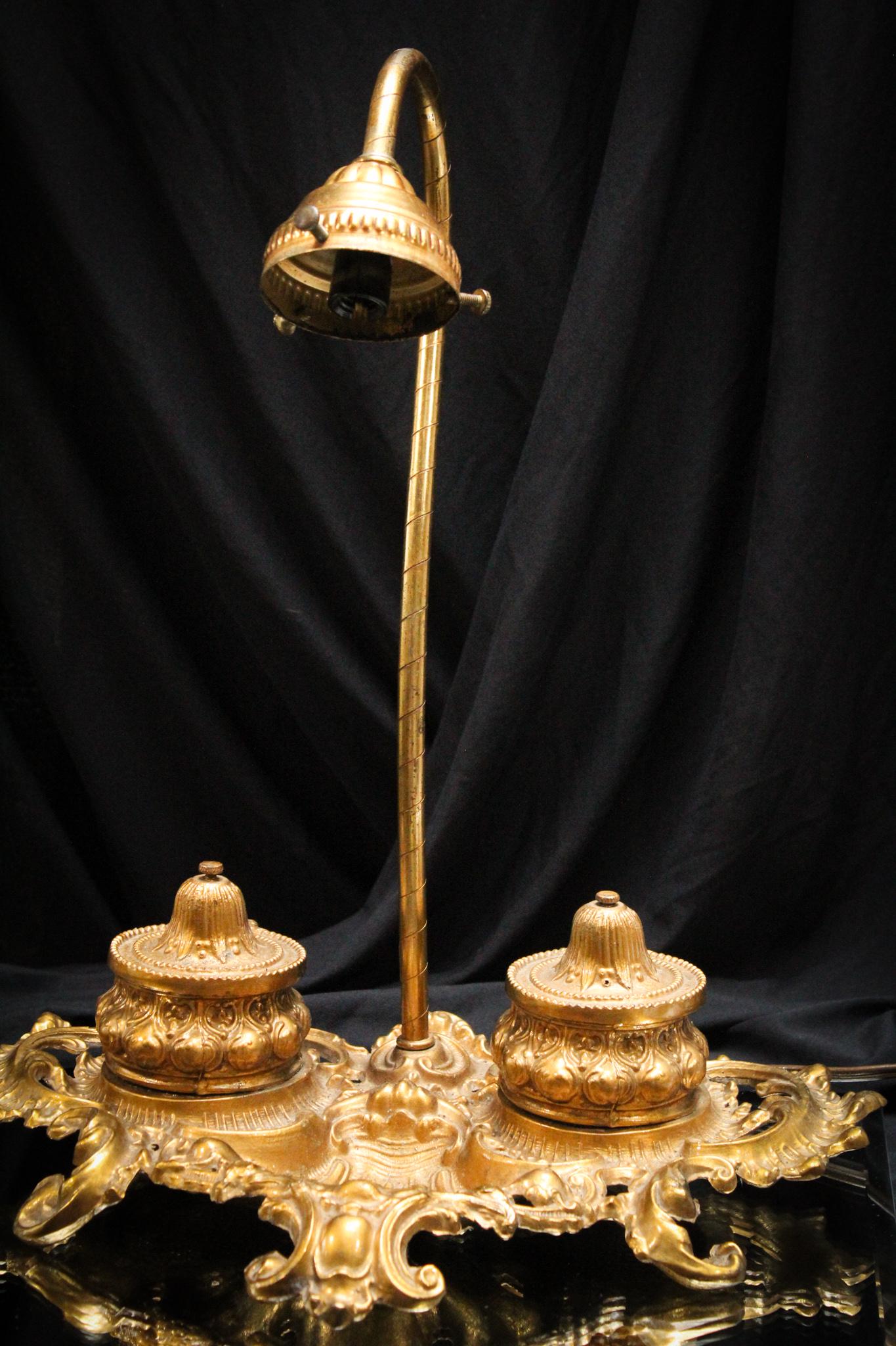 Antique Double Inkwell Ornate Desk Lamp: Complete this piece with your favorite art glass manufacturer shade, and you will have one amazing piece! Ornate brass desk lamp with double inkwells is quite the find here. Measures 14 1/2" tall.