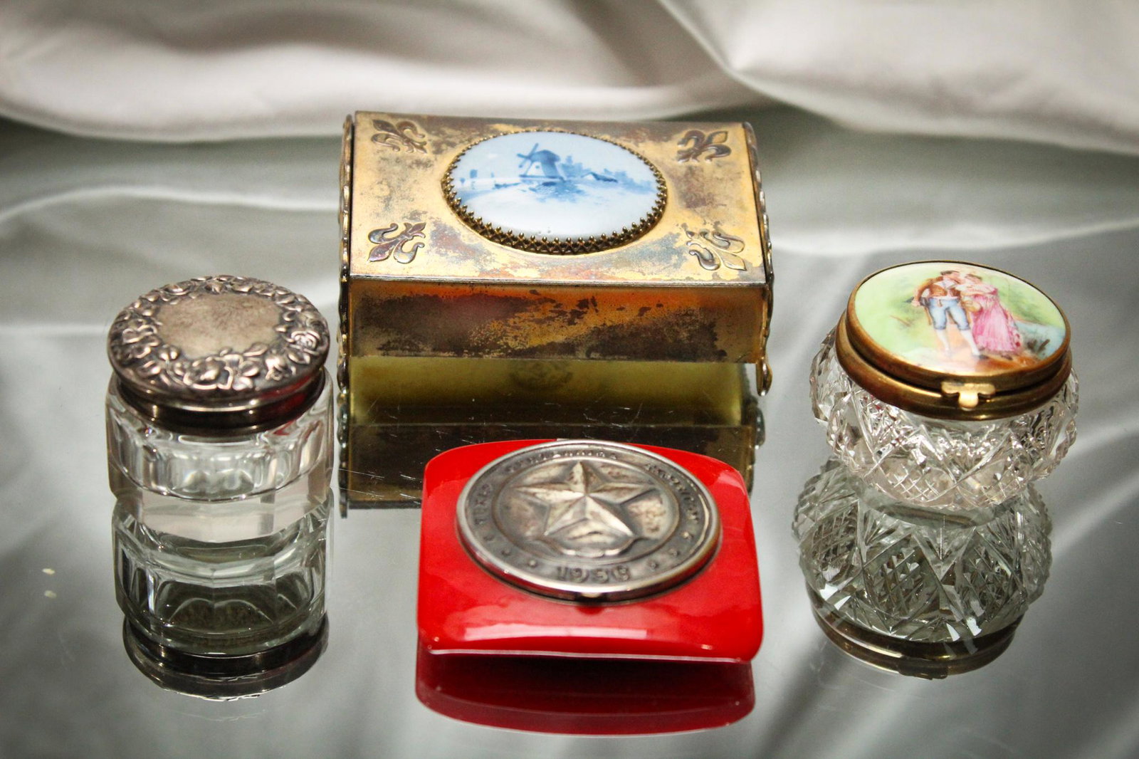 Lot of 4 pc Victorian Pin/Pill Boxes: What an array we have here folks. Offered is a Porcelain lid on glass, a sterling silver lidded glass example, a Texas Centennial plastic compact dated 1986 and a Pairpoint silverplate with enameled d