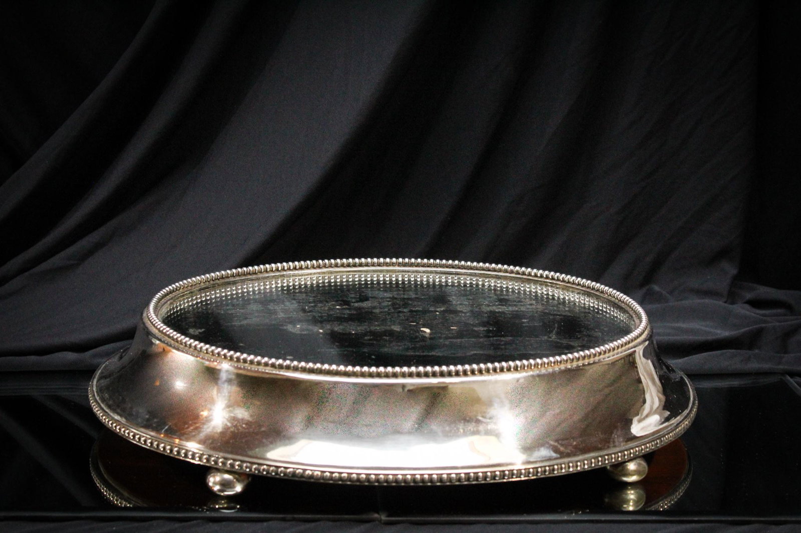 Oval Silverplate Plateau Mirror: Nice oval plateau mirror. Pleasing silverplate frame. Perfect to showcase that special treasure! Measures 16" at the widest portion.