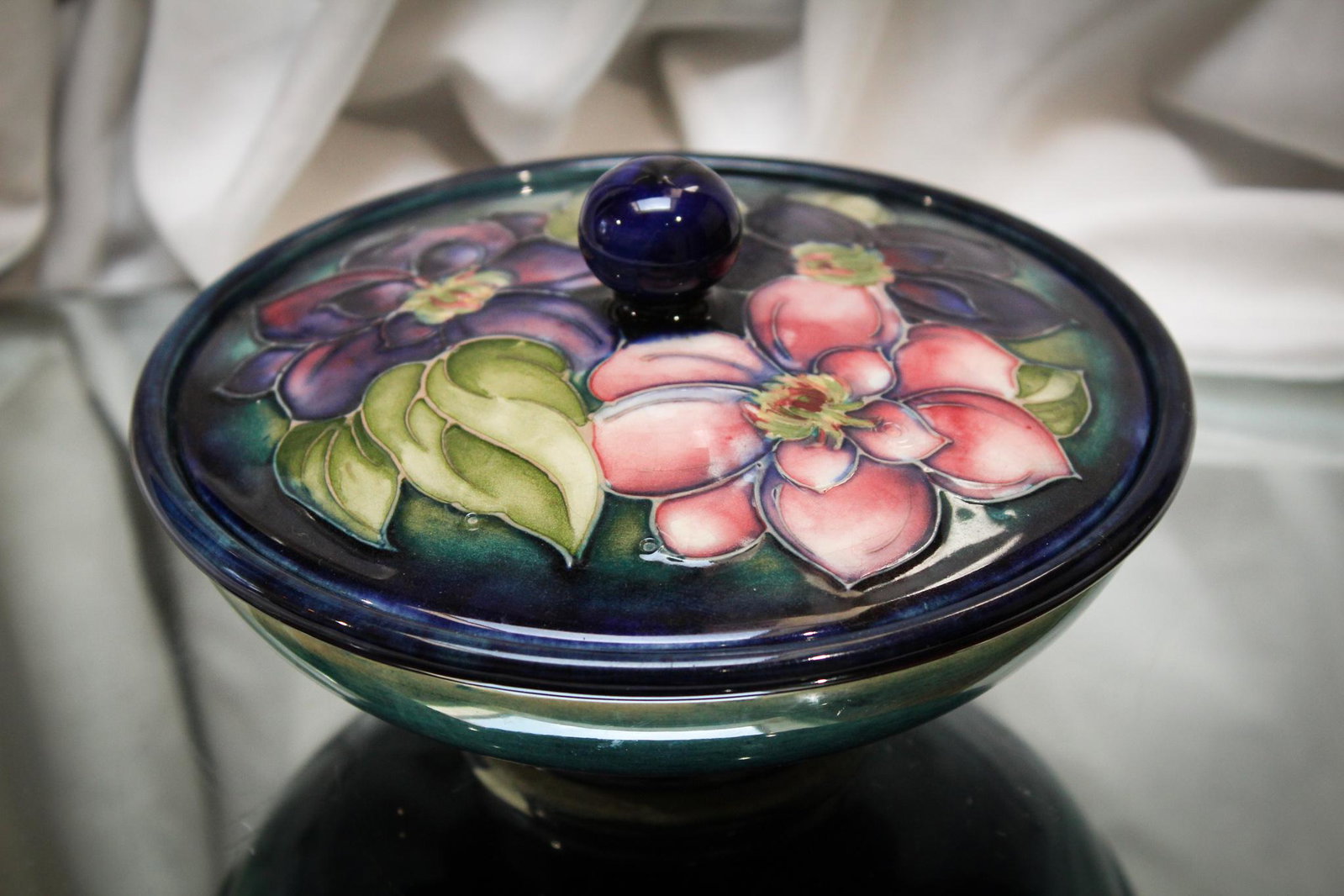 Moorcroft Pottery Floral Covered Candy Bowl: Such a nice example of Moorcroft pottery. Floral motif dÃ©cor adorns this covered piece. Measures 2 3/4" by 6".