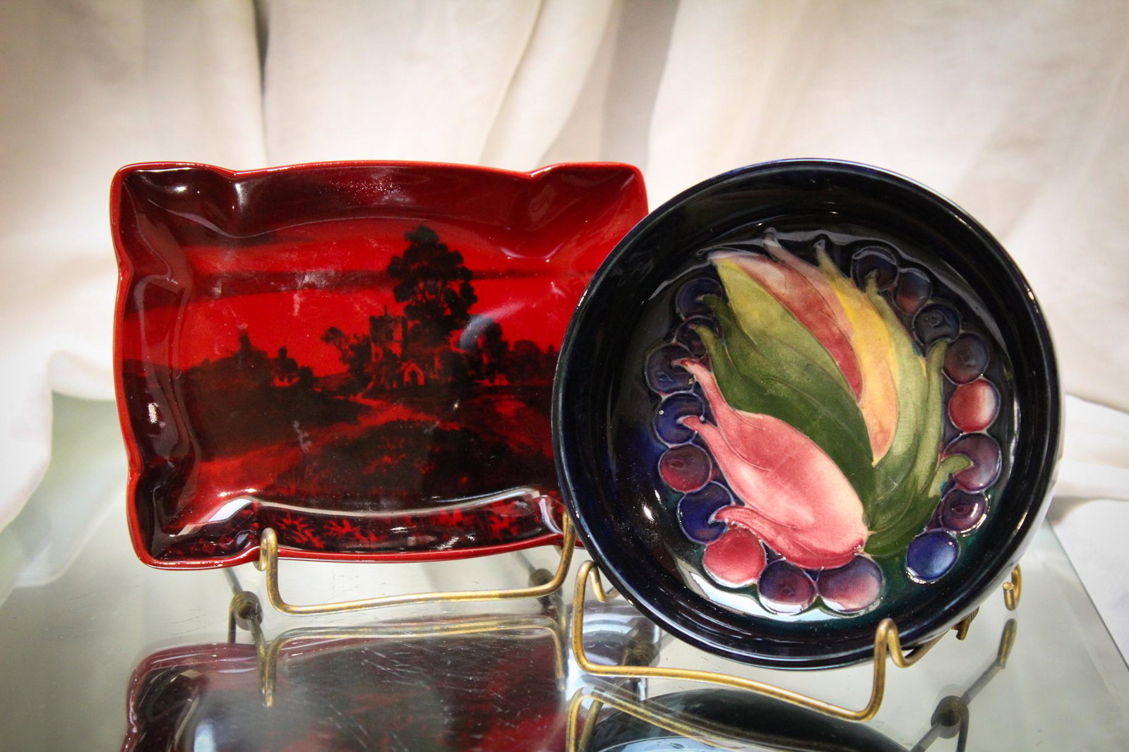2 pc. Lot Moorcroft Pottery & Royal Doulton Flambe: Here is a pairing of two pieces of wonderfulness. A Moorcroft pottery bowl and a Royal Doulton Flambe ashtray. Largest measures 5 1/2".