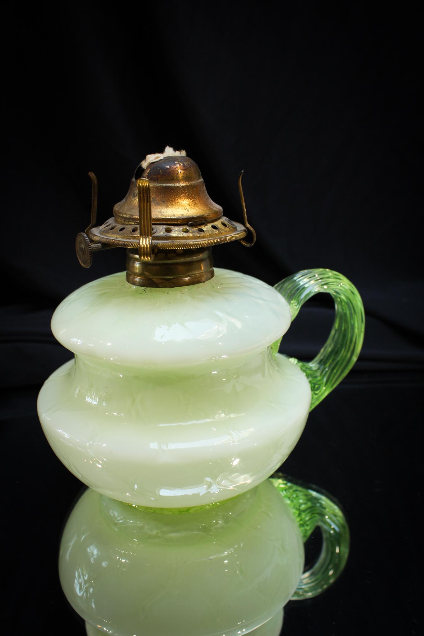 Rare Vaseline Cased Glass Finger Oil Lamp: This is one fine lamp folks. Beautiful vaseline cased glass and drape pattern makes up this gem of a lamp. Complete with vaseline applied handle. Measures 4" tall.