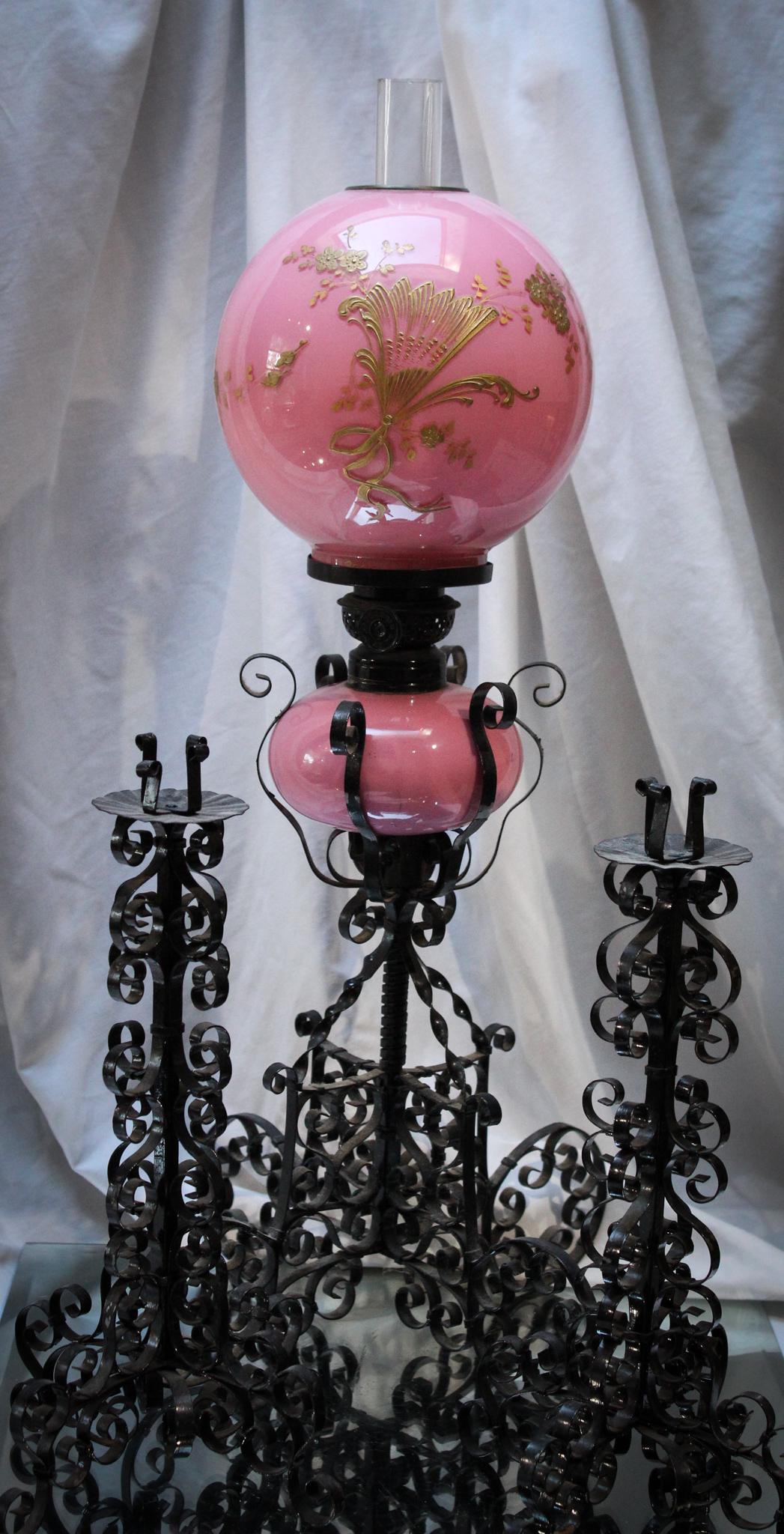 Very Rare Victorian Pink Cased Gilt DÃ©cor Jr. Oil Lamp Console Set: Take notice here, folks! This is a very rare Victorian Pink cased glass Jr. size oil lamp with twisted metal base and matching candlesticks. Unlisted lamp and fantastic decoration here. What a perfect