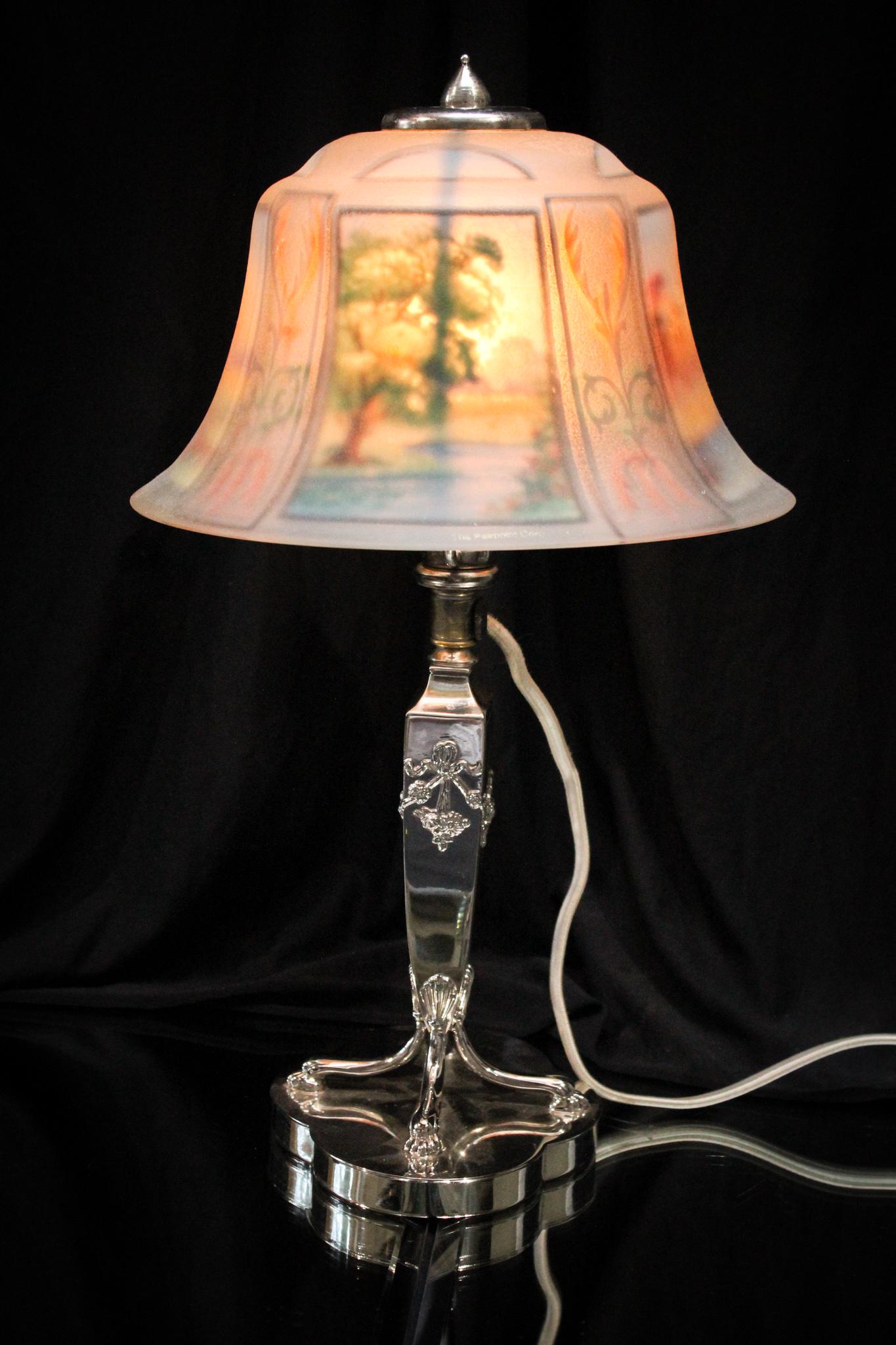 Pairpoint 4 Seasons Exeter Reverse Painted Lamp: Sweet signed shade and base Pairpoint Exeter shade Boudoir lamp. Shade is decorated with the four seasons dÃ©cor. Silverplate original Pairpoint base. Measures 18" tall and 8 1/2" in diameter.