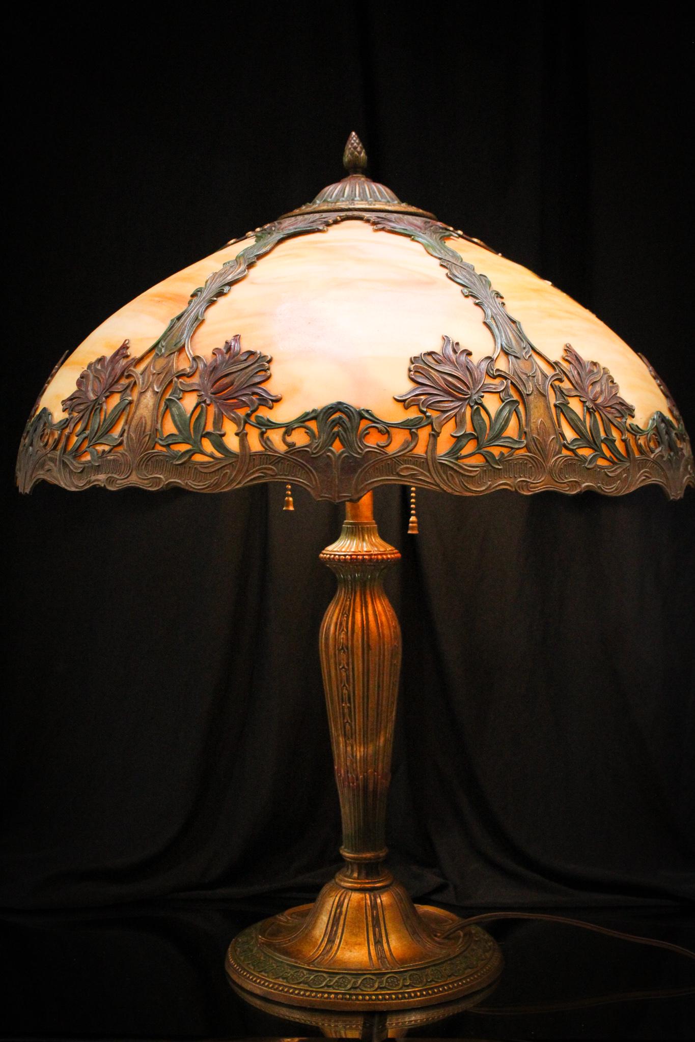 Art Nouveau Bent Panel Slag Glass Table Lamp: Stunning bent slag glass panel lamp lamp with original patina to the frame and base. Beautiful lamp measures 23" tall.
